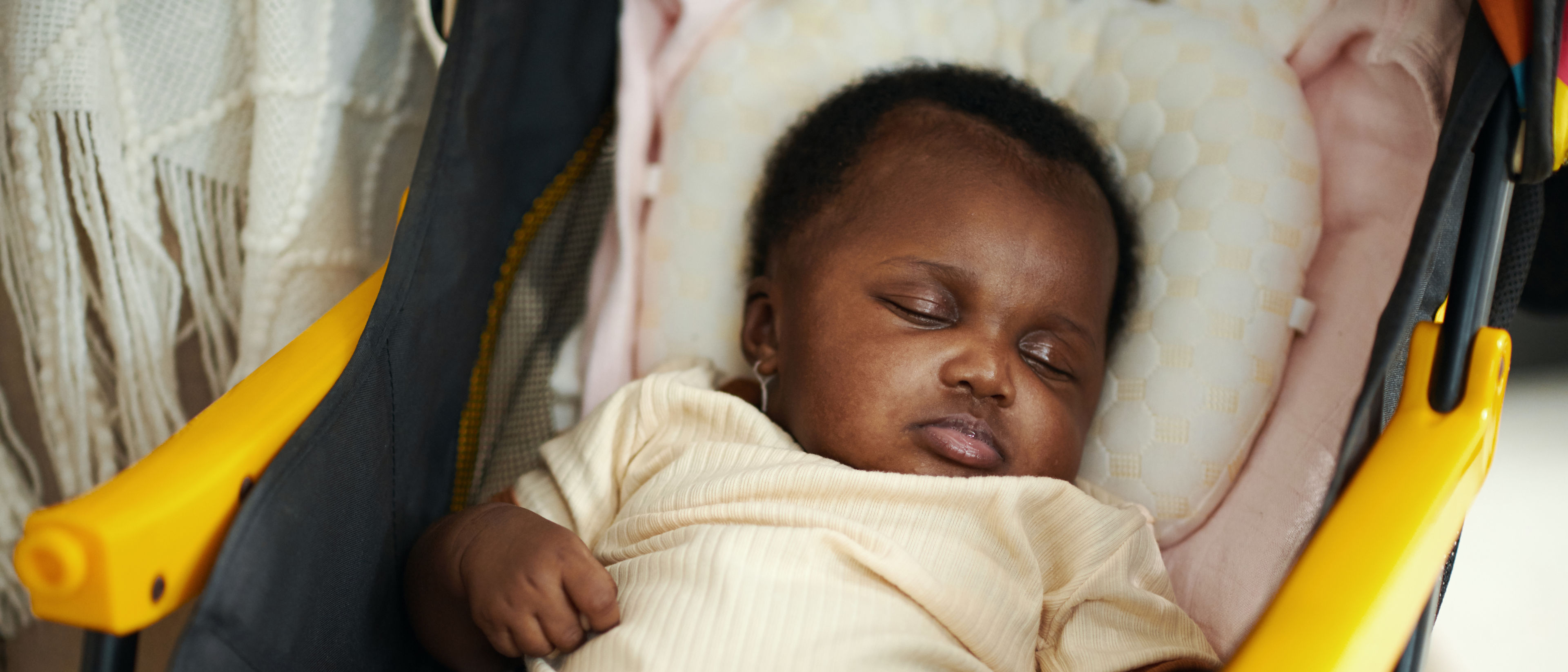 baby sleeping in a stroller