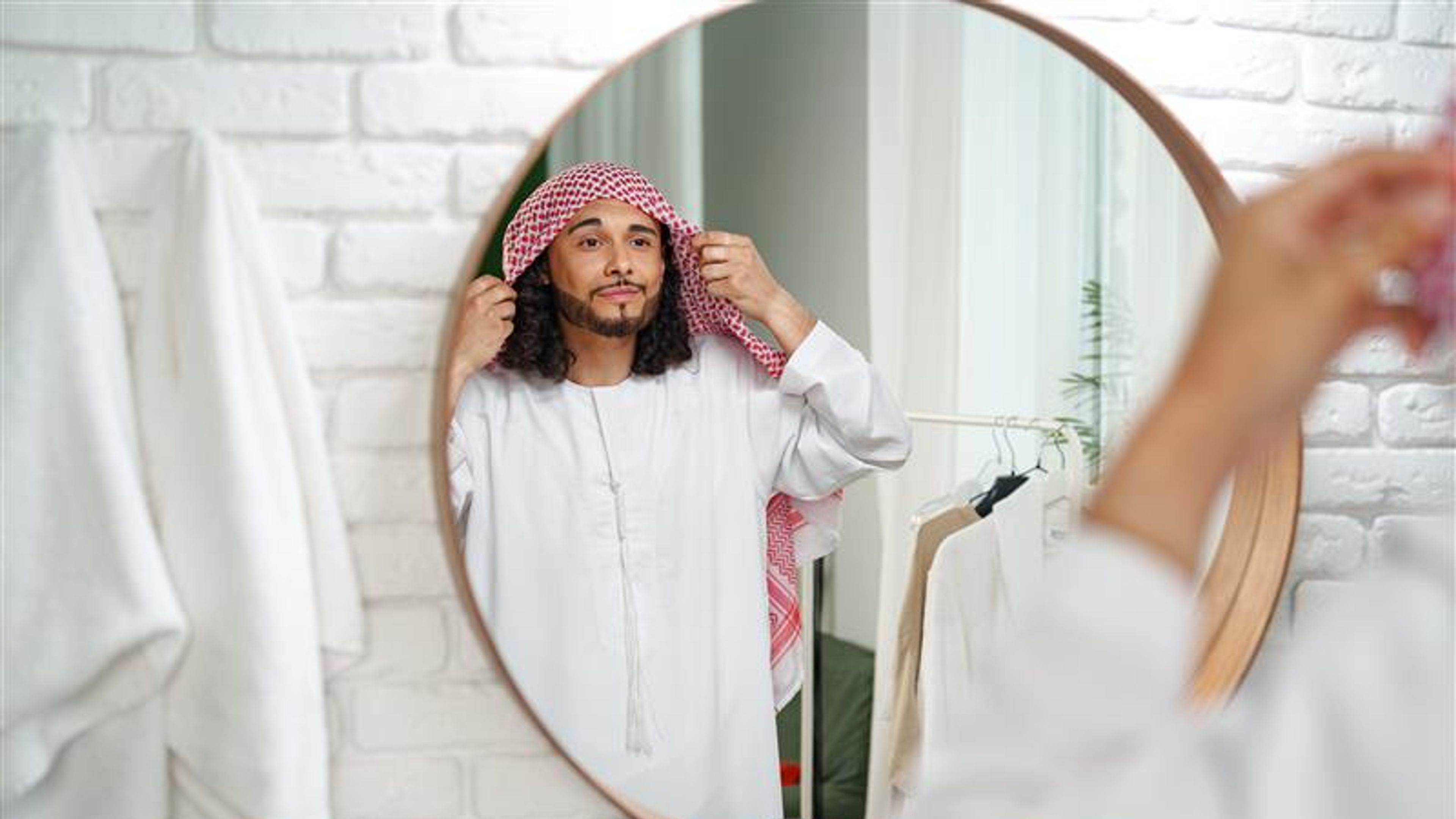 A man getting ready in front of a mirror 