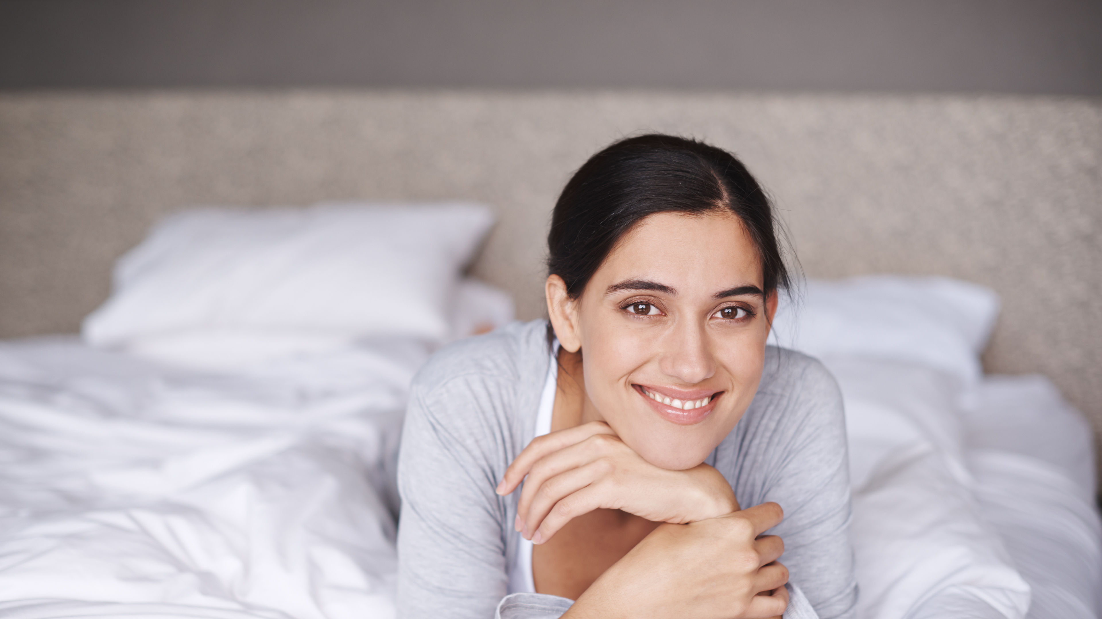 A woman in a bed relaxing.