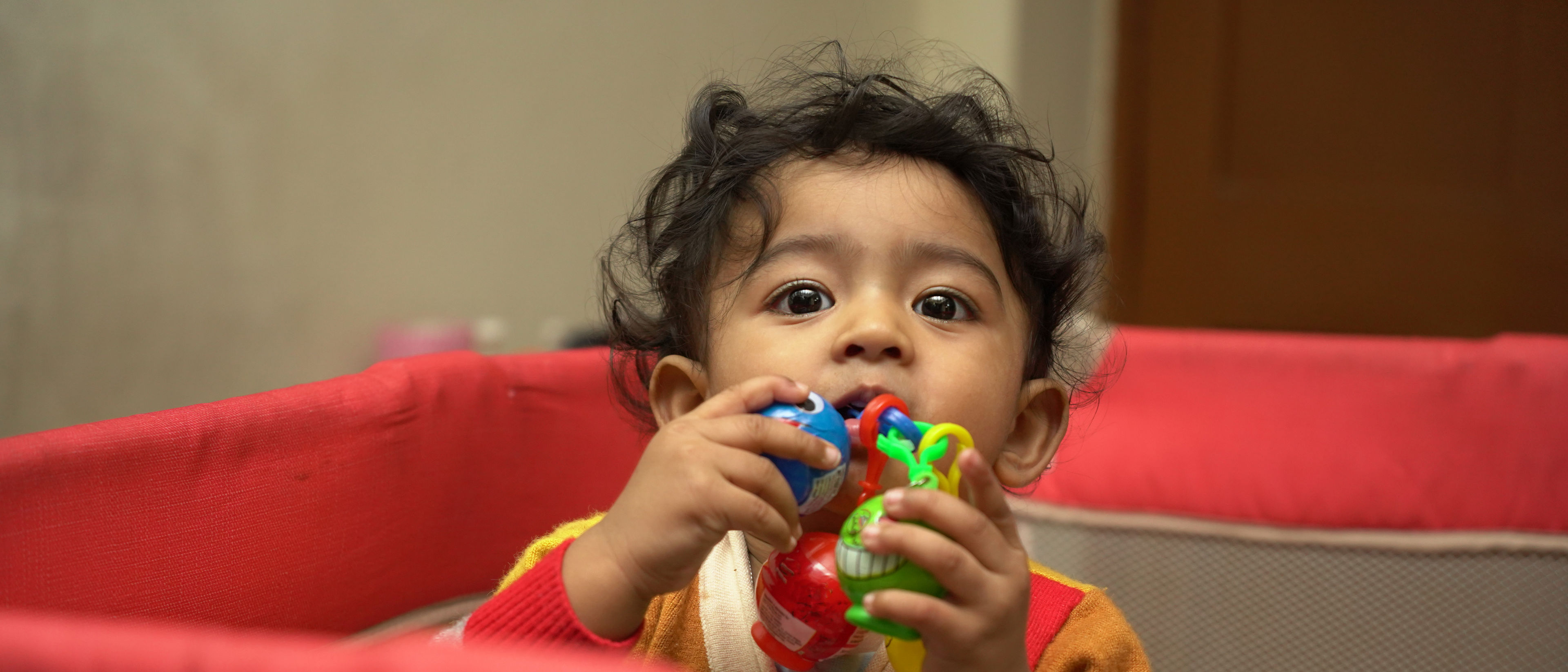 baby playing in a play pen