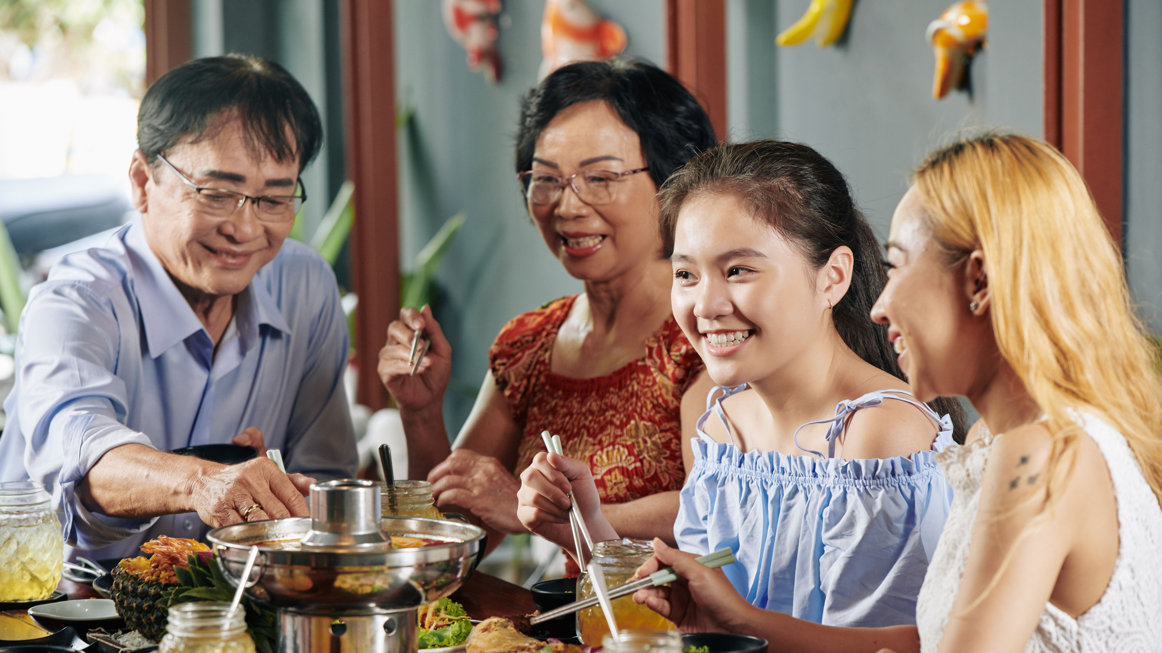 A happy family of four enjoying dinner 