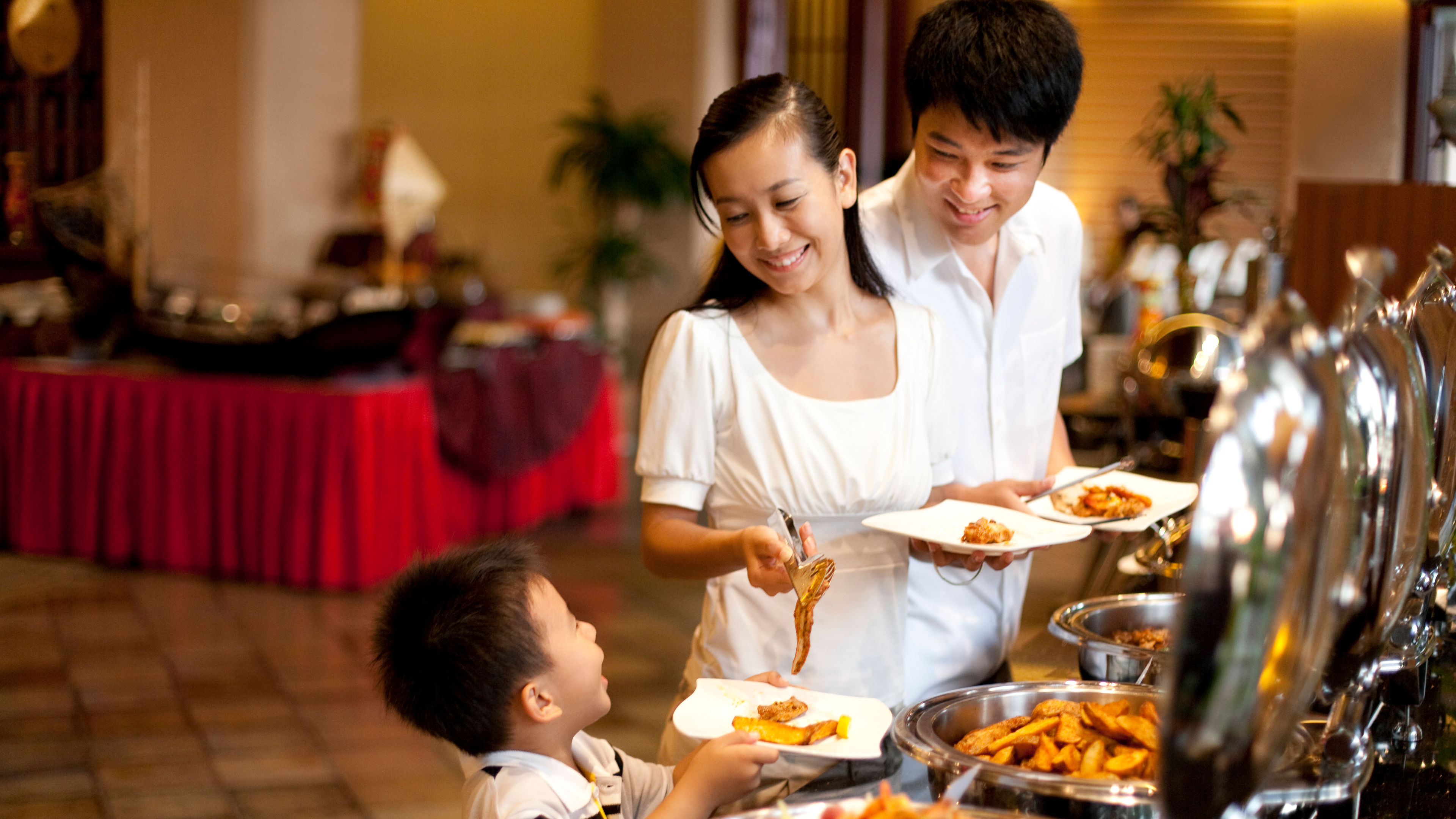 A beautiful family enjoying buffet in a restuarant 