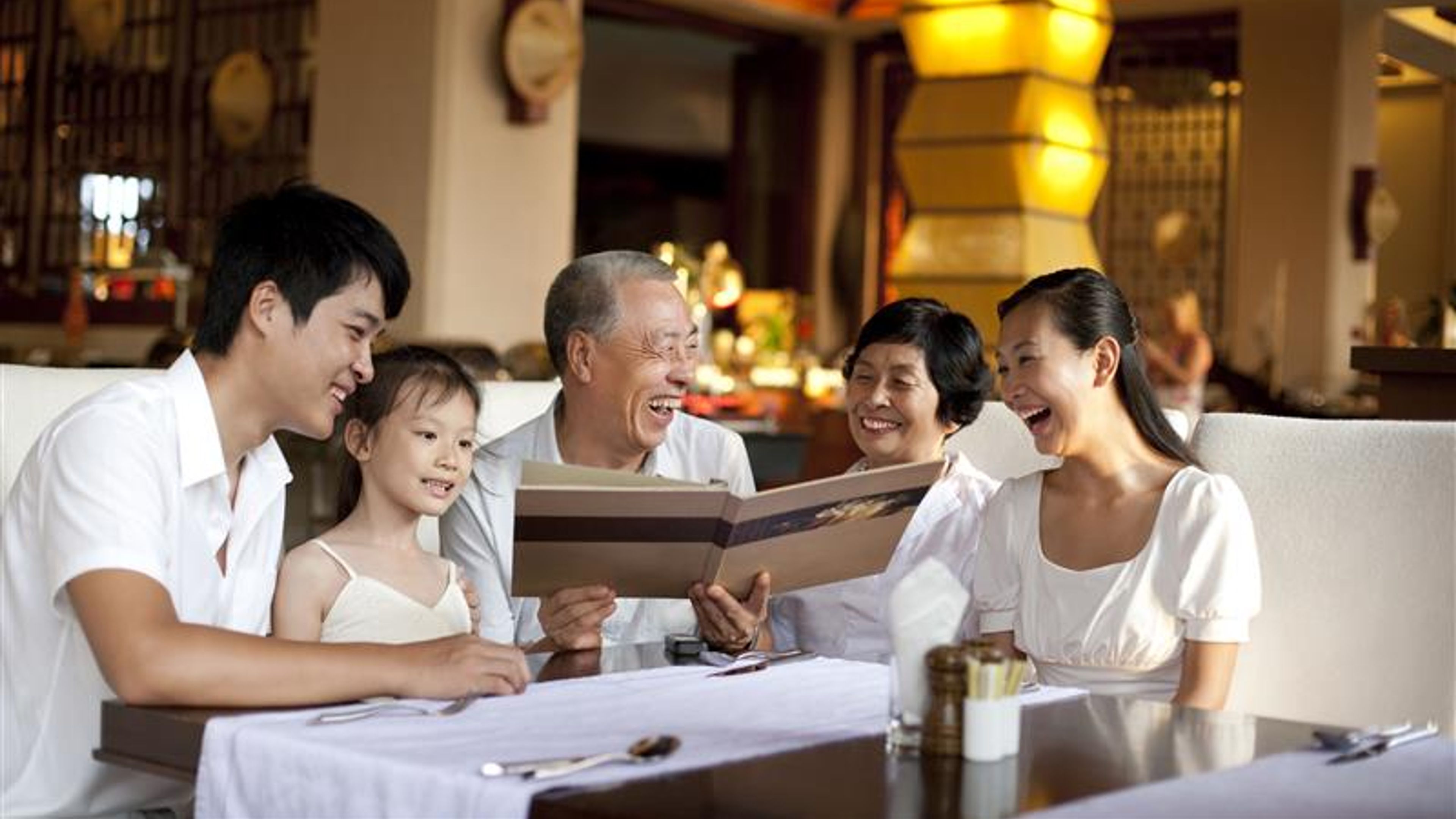 A happy family enjoying food at a hotel 