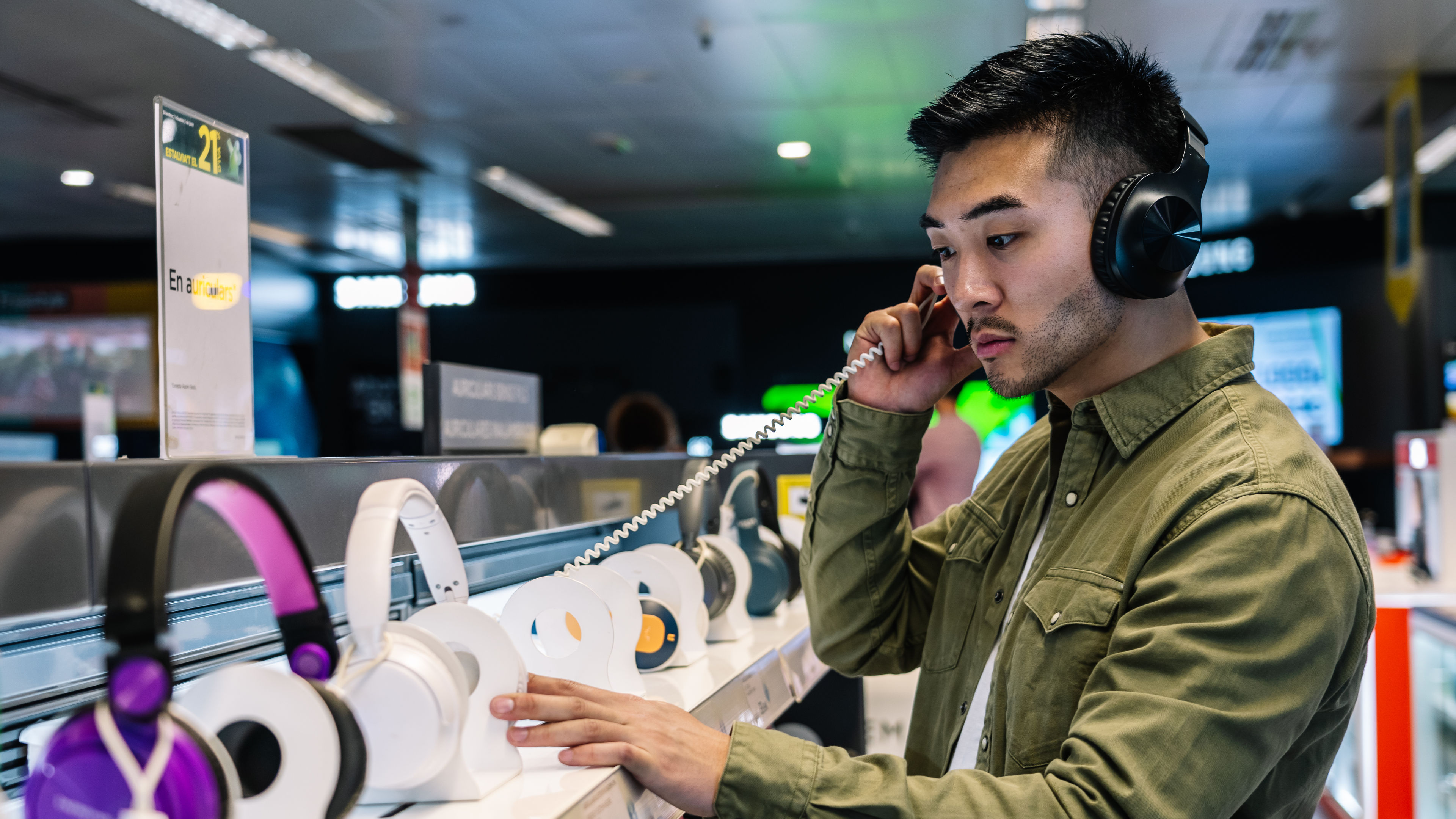 A young man choosing headphones 