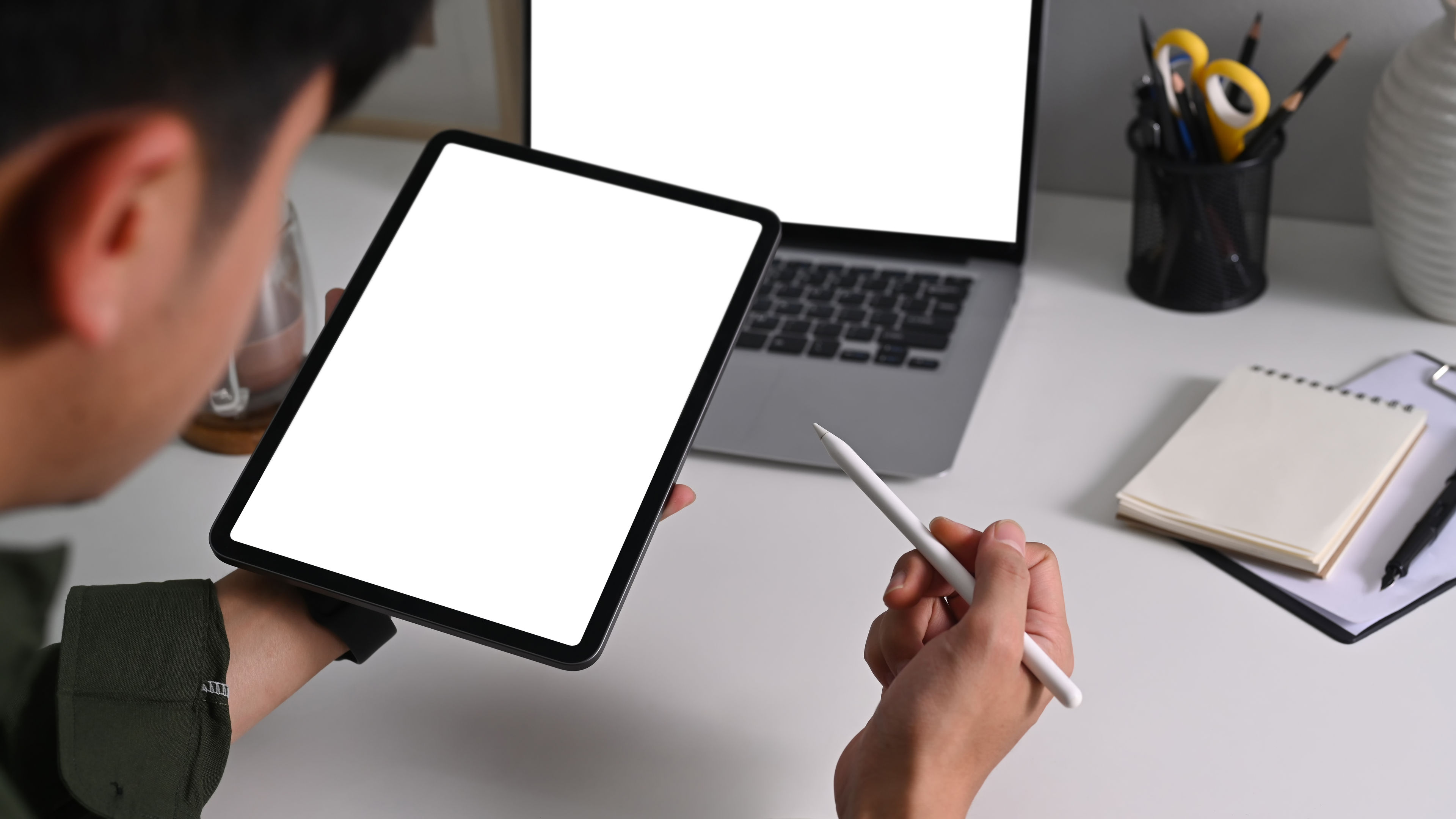 A young man using a tablet with digital pencil 