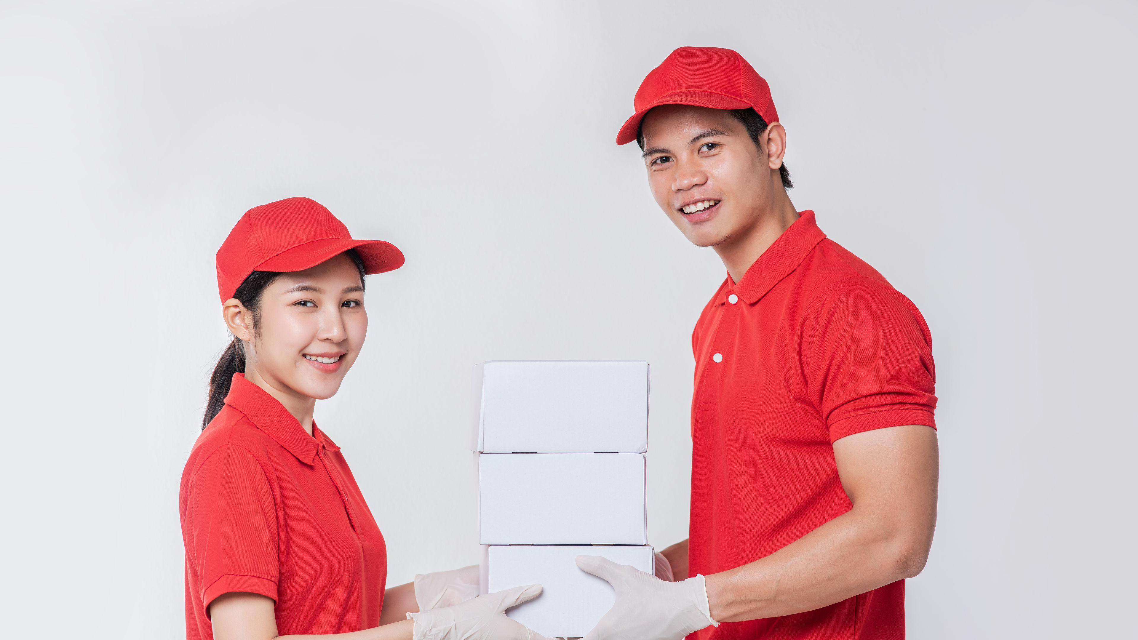 A woman and a man in red dresses during courier delivery 