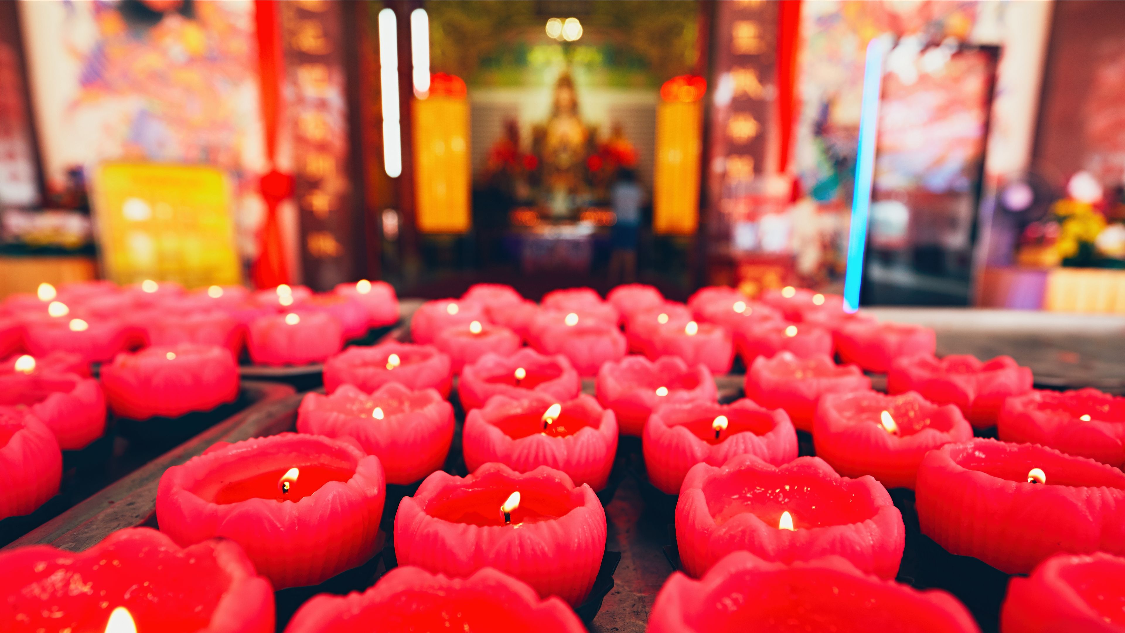 A serene view of glowing red candles in a Chinese temple creating a peaceful ambiance 