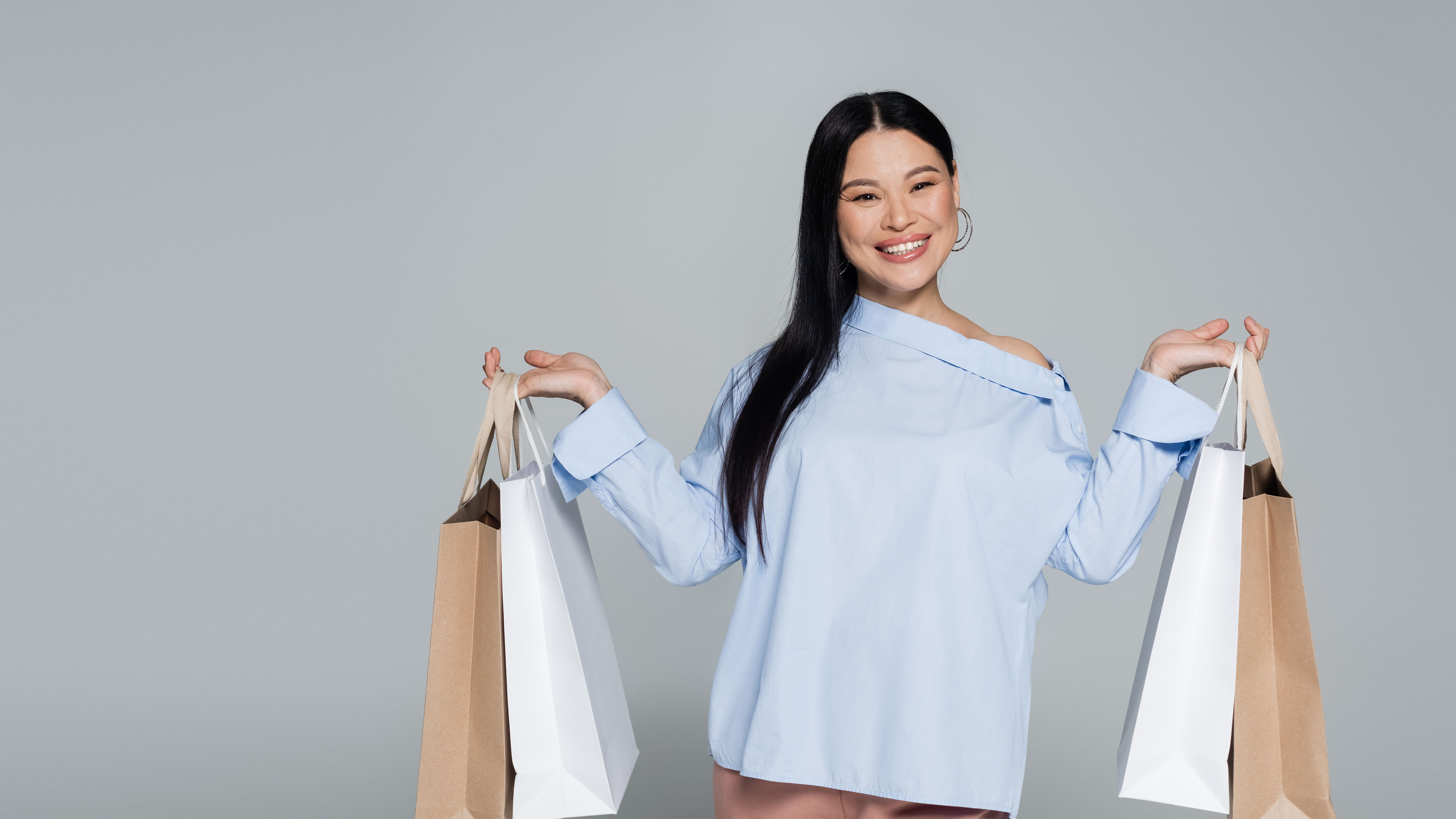 Image of a cheerful asian woman in blouse 
