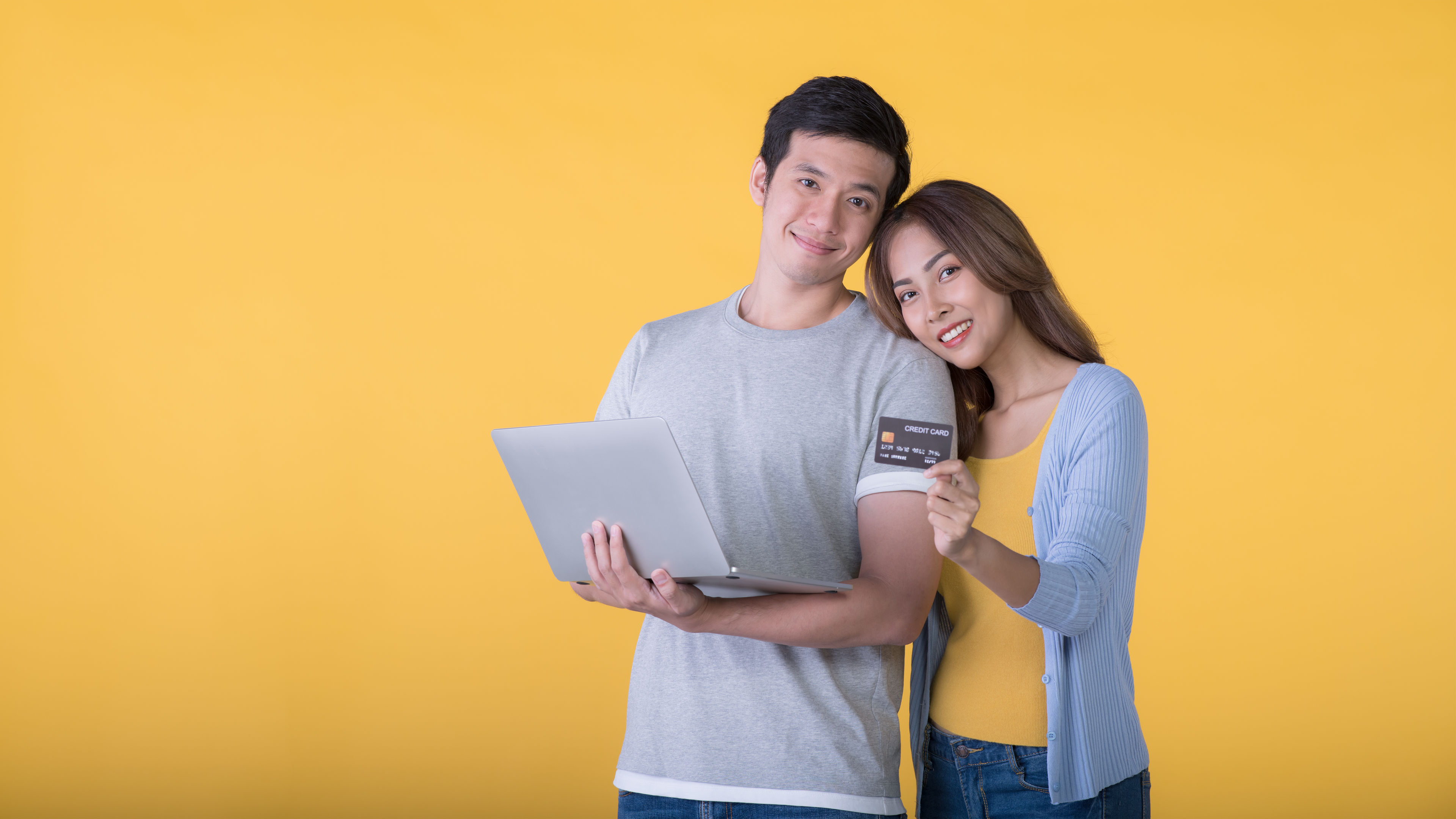 Image of Couple with laptop and card 