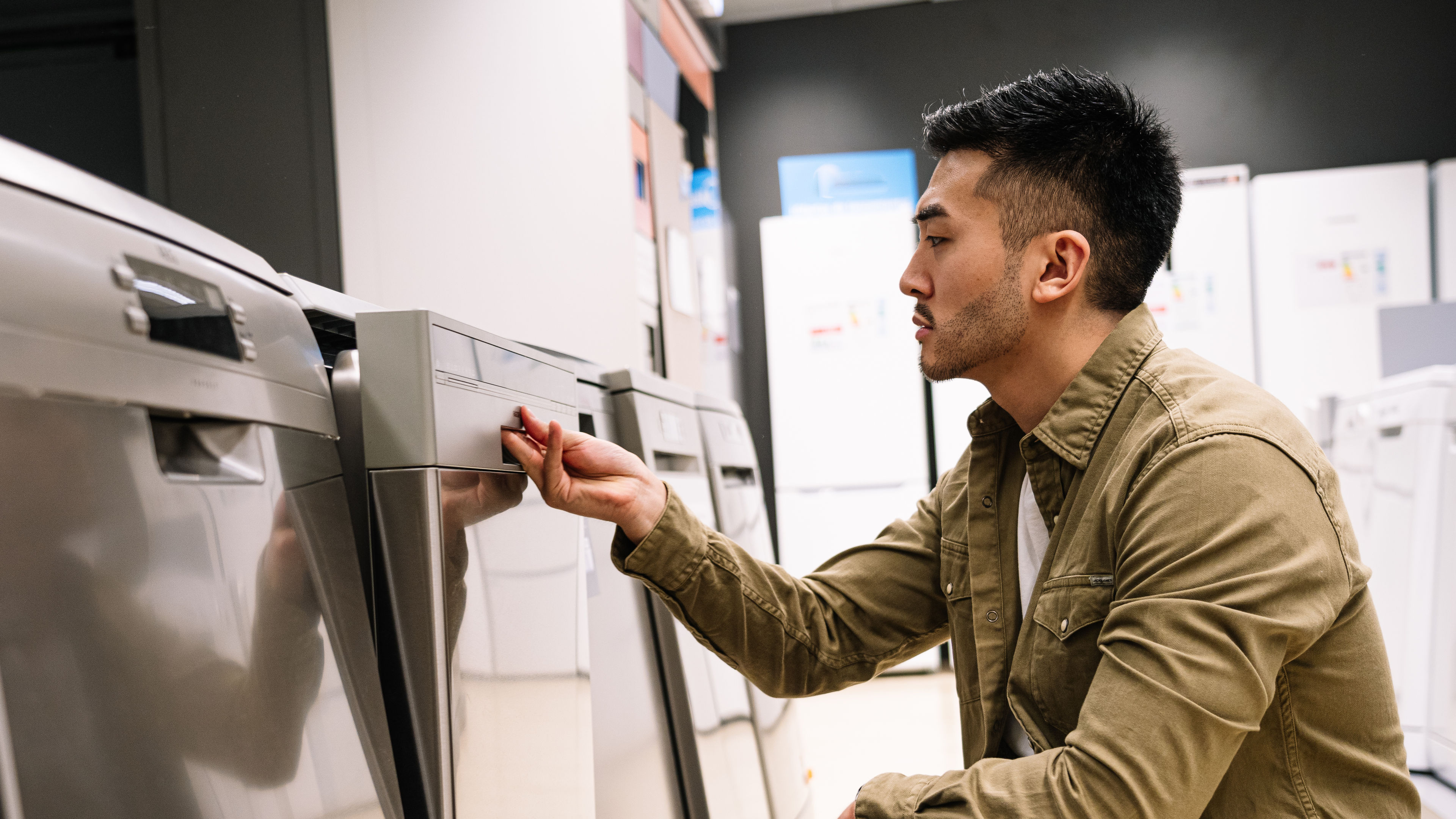 Customer Checking Features of Home Dishwashers in store 