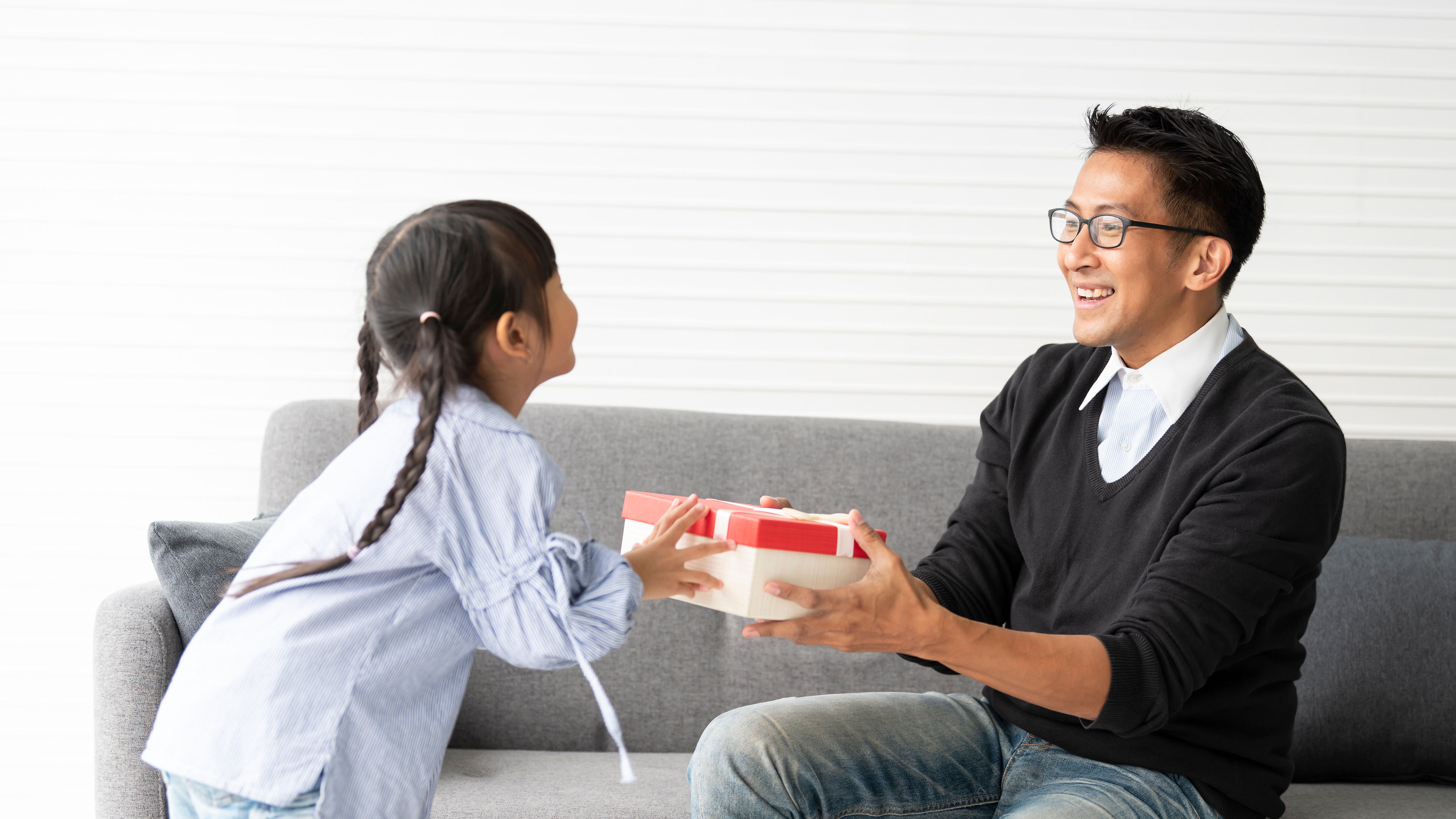 Asian daughter give present for father. concept surprise gift box for father's day. 