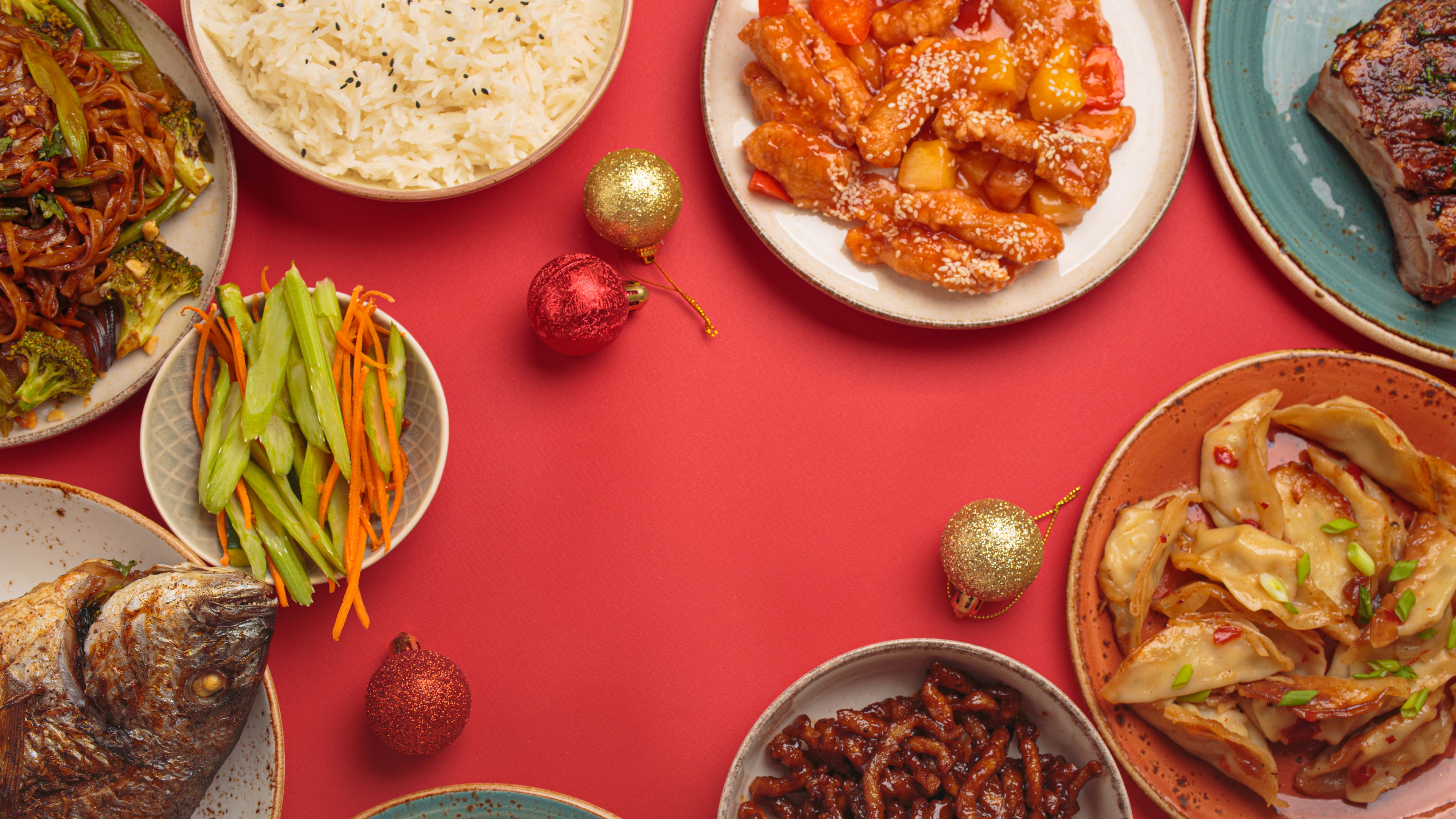 A vibrant table filled with traditional Chinese dishes and festive decorations 