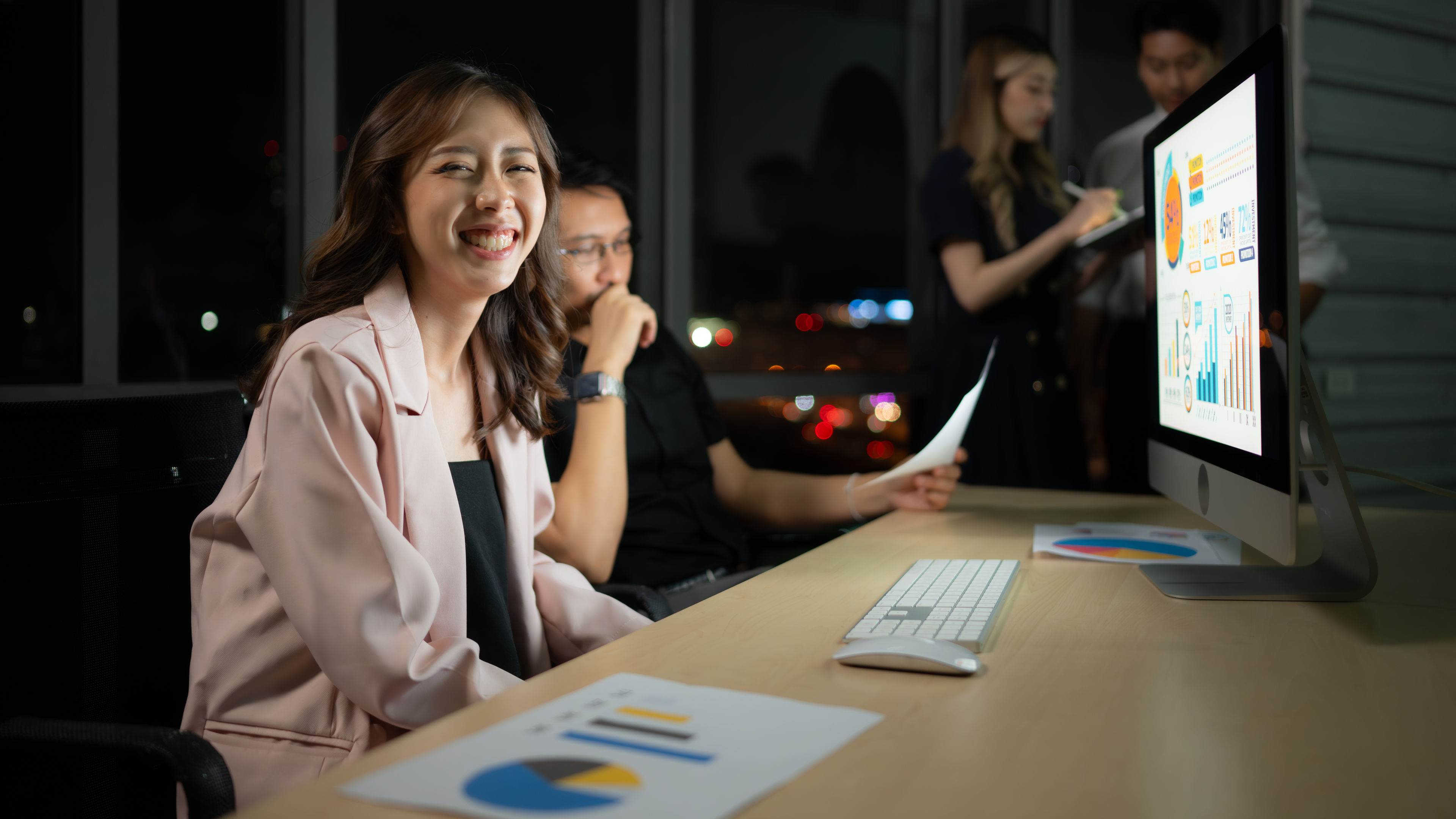 Group of business people working in office at night. Business concept. 