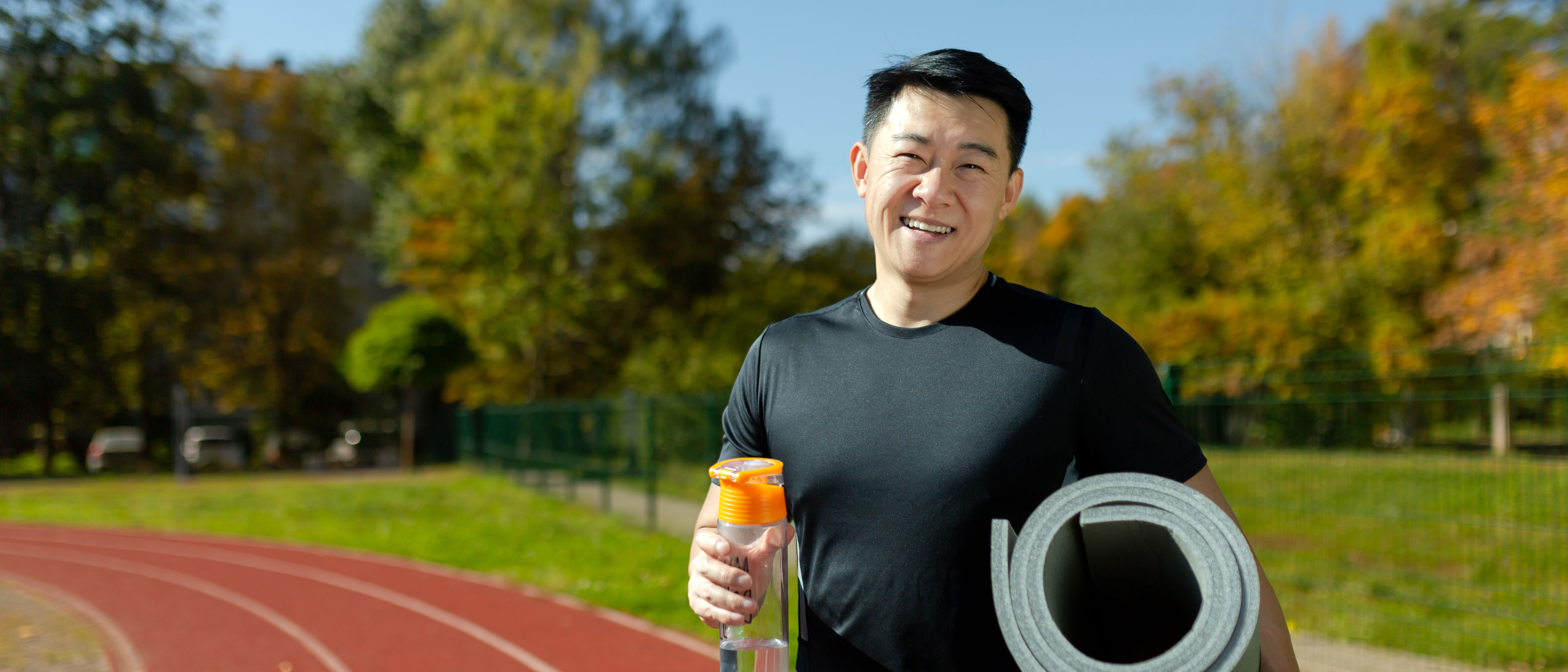 Man holding yoga mat