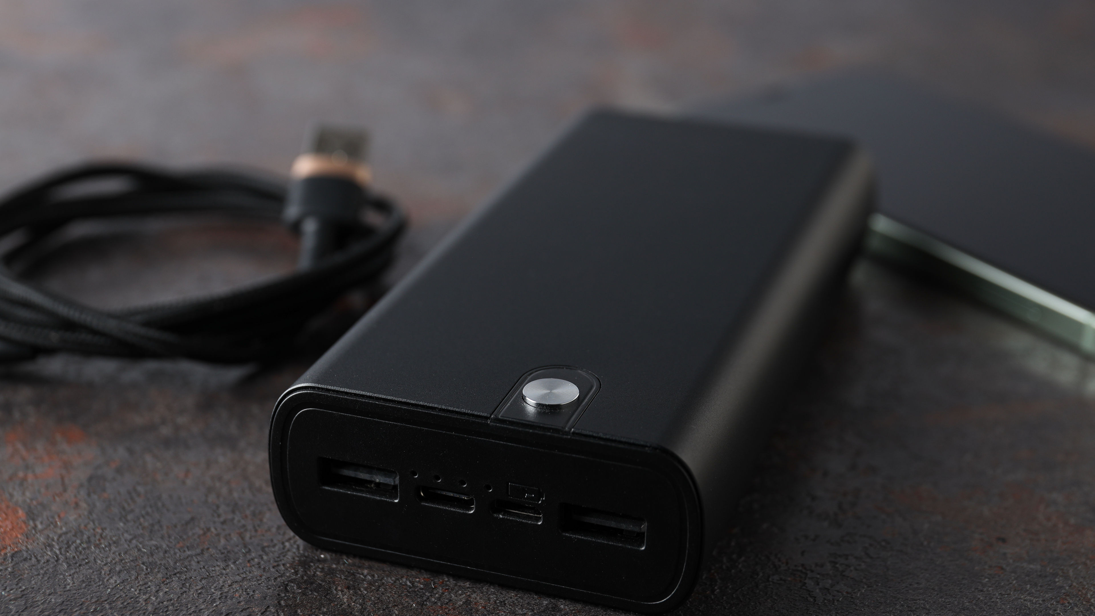 Image of Powerbank cord and smartphone on table 