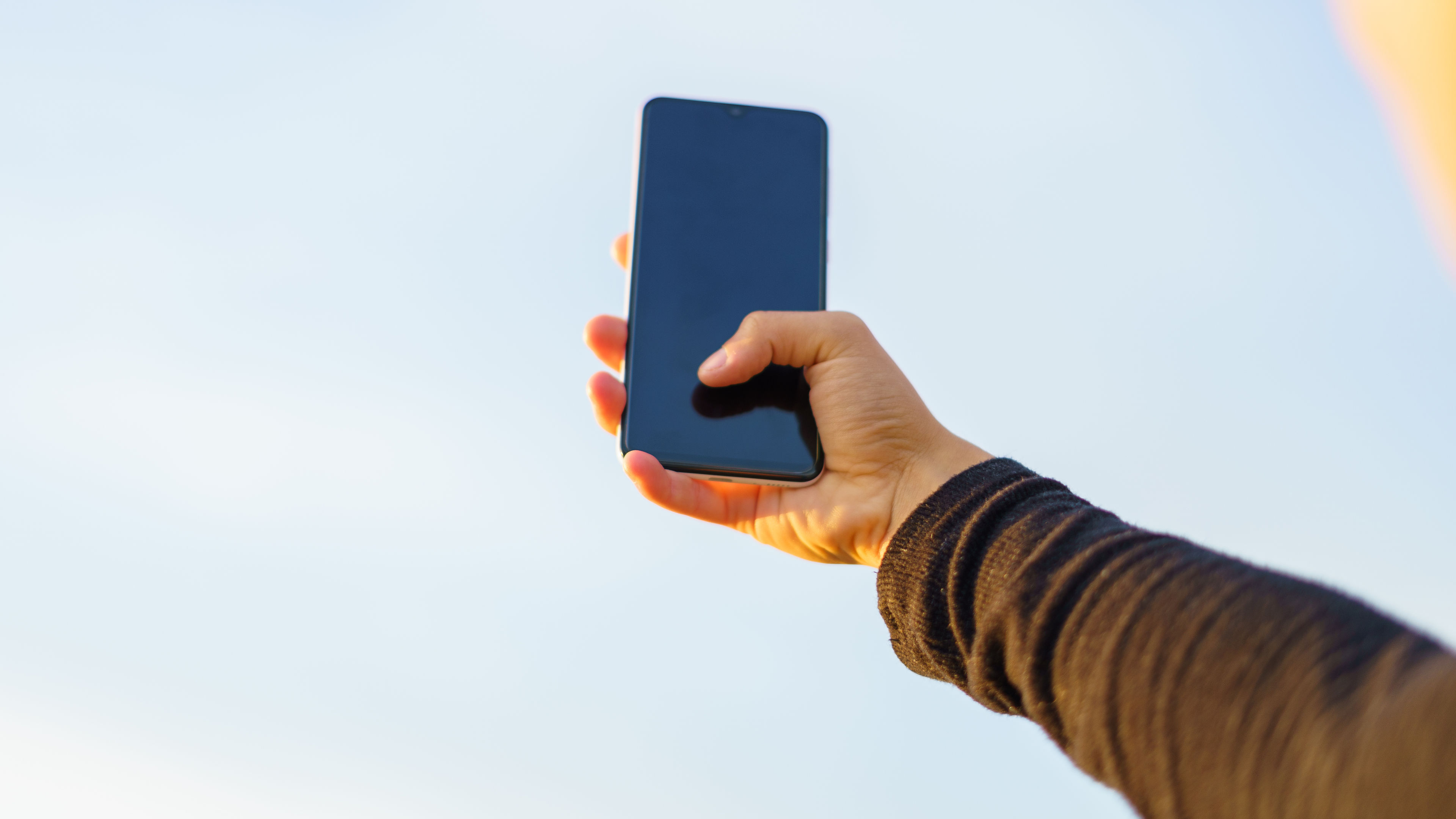 Unrecognizable young woman taking a selfie with a smartphone 