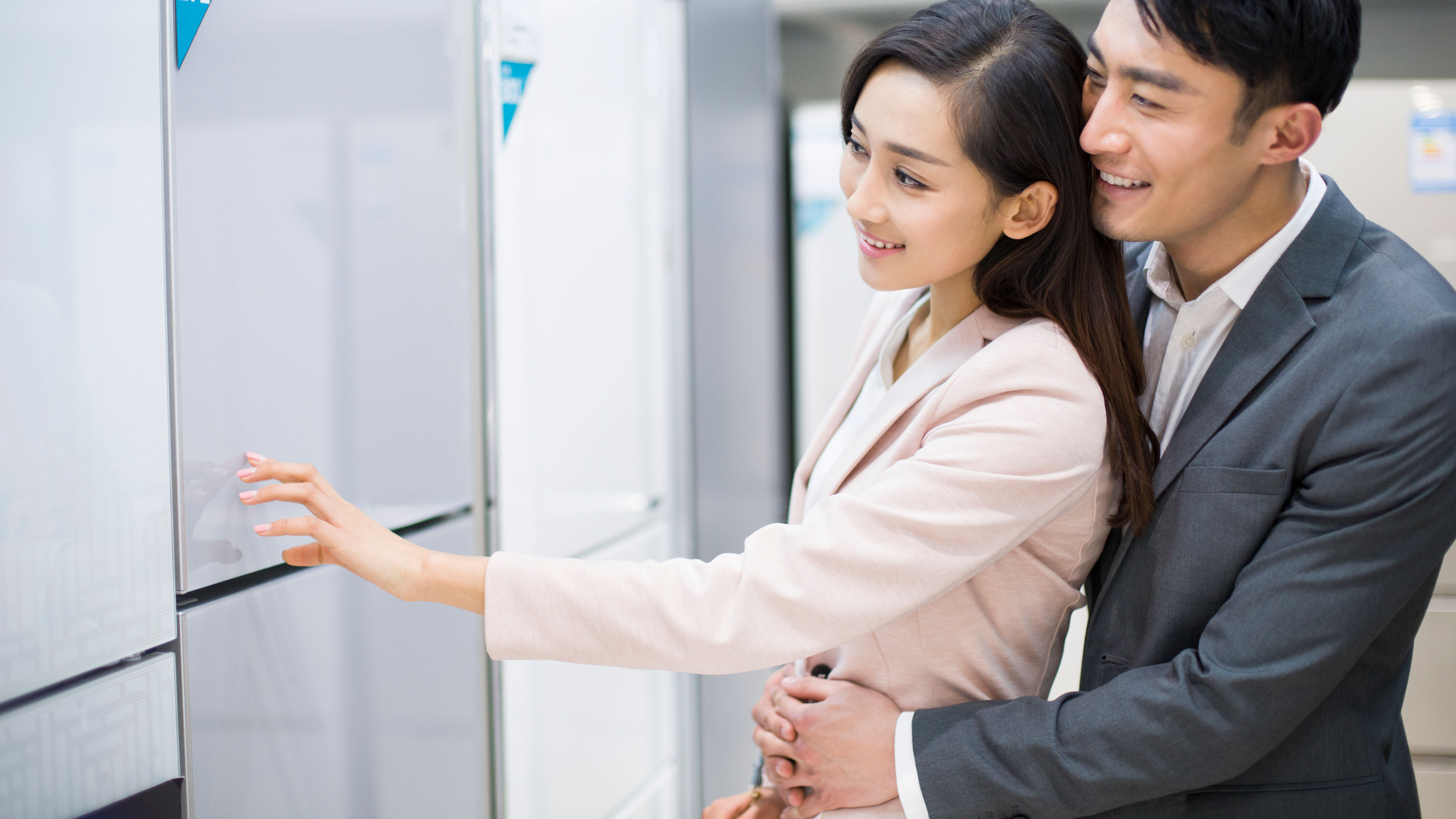 Young couple buying refrigerator