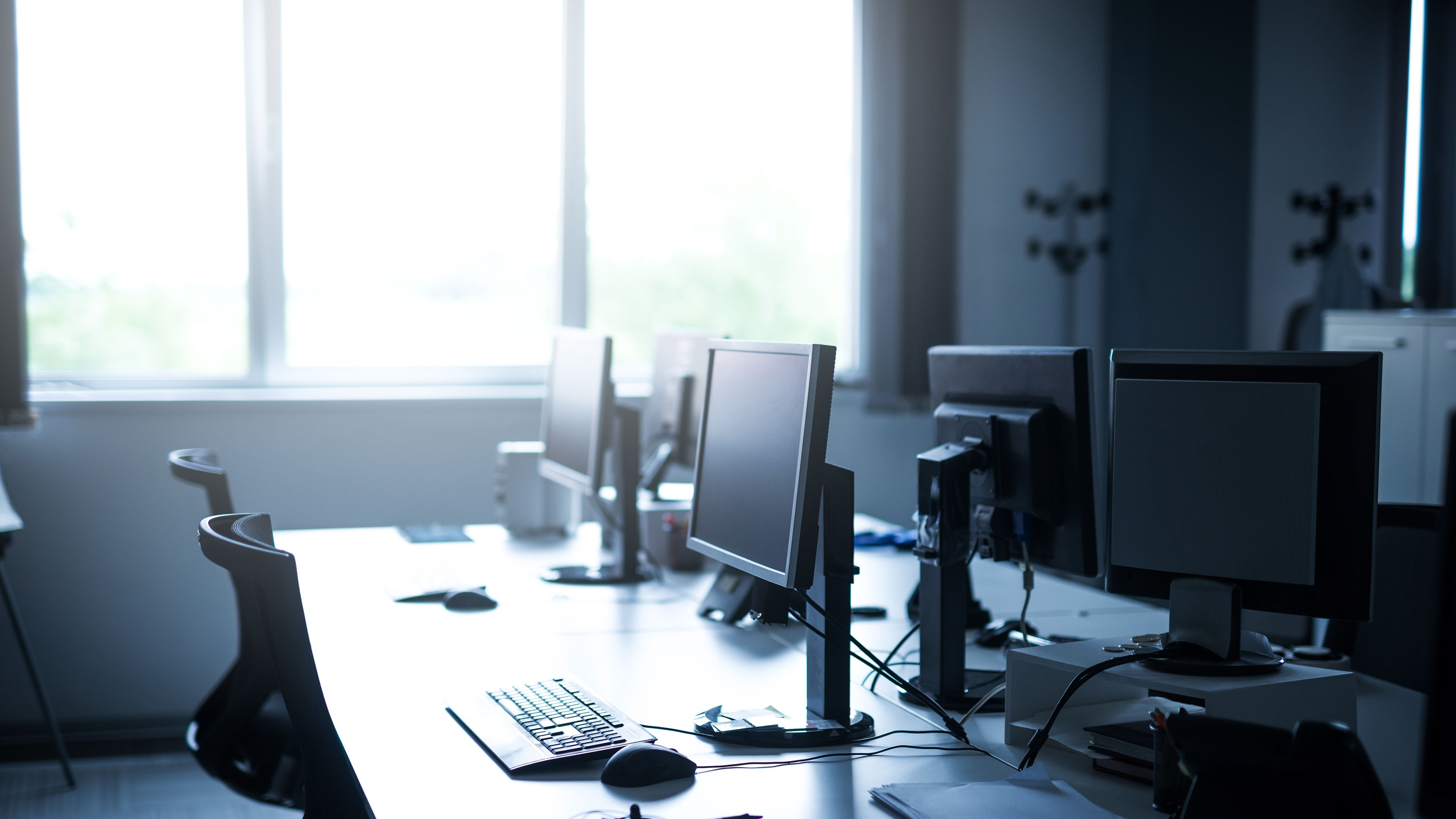 A spacious and immaculately designed coworking space, completely empty and showcasing a professional yet inviting atmosphere. 