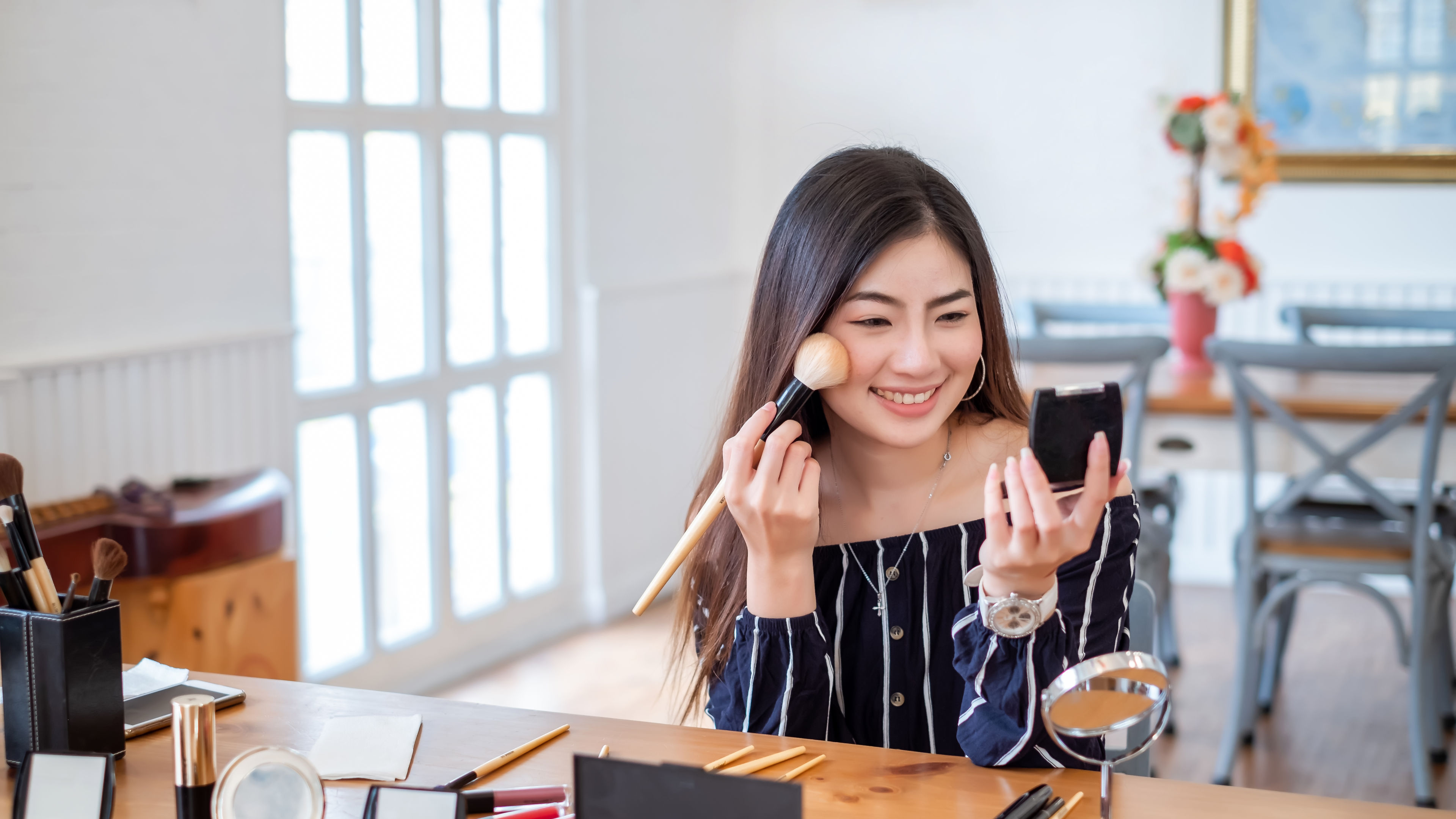 Asian girl is using cosmetic products