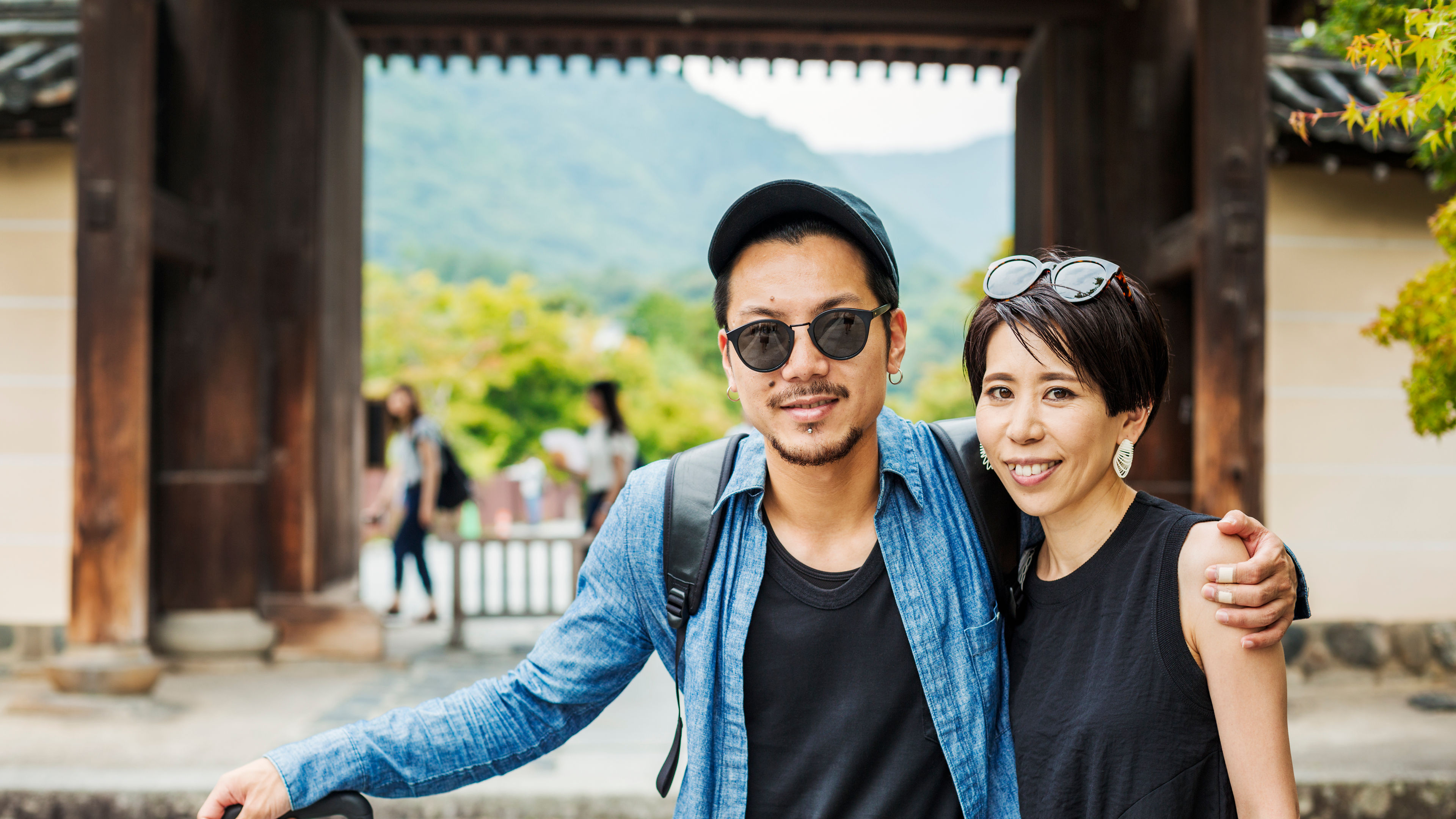 A man and woman visiting a historic temple in Japan. 