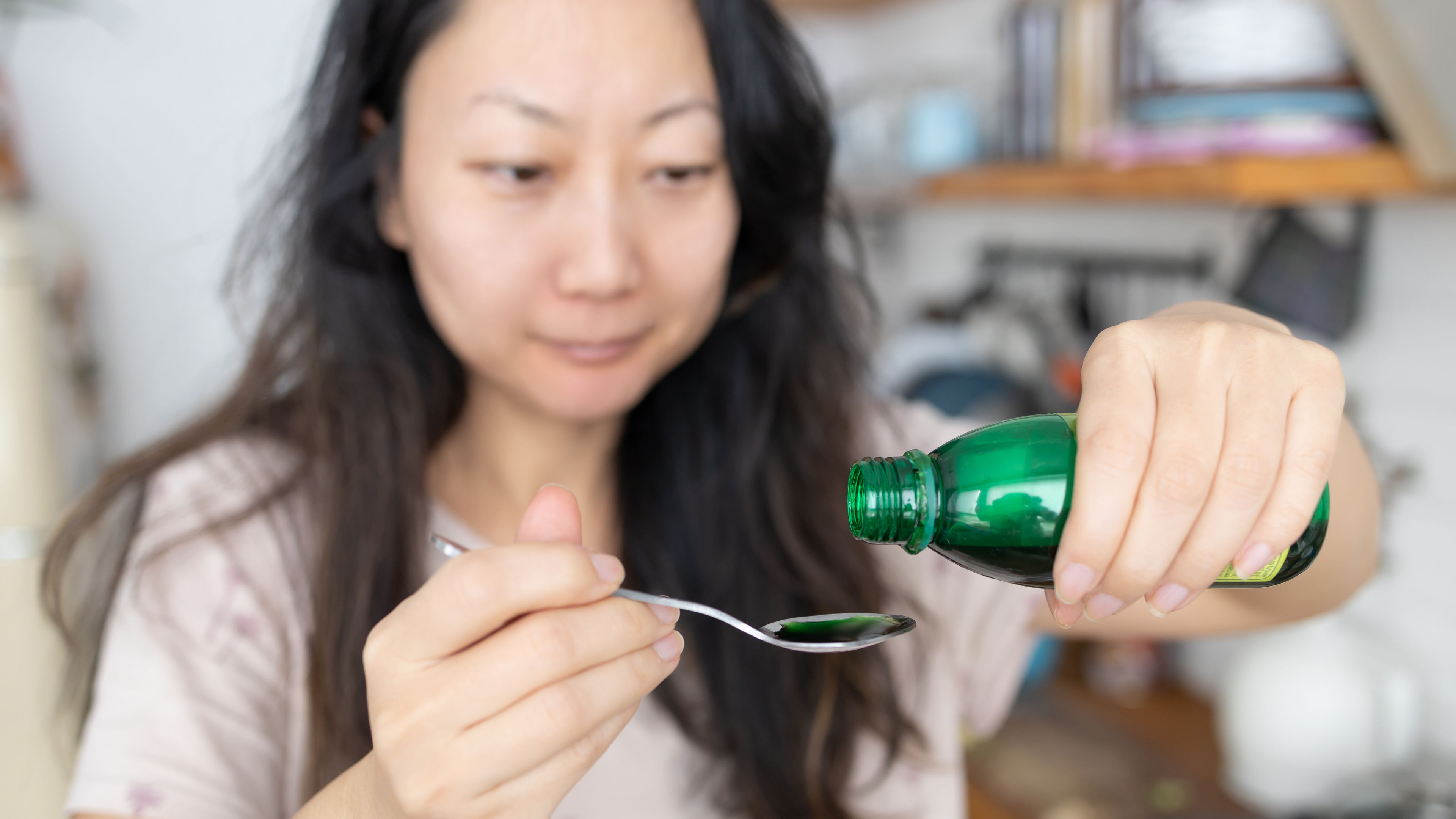 A middle-aged woman trying some medicines 