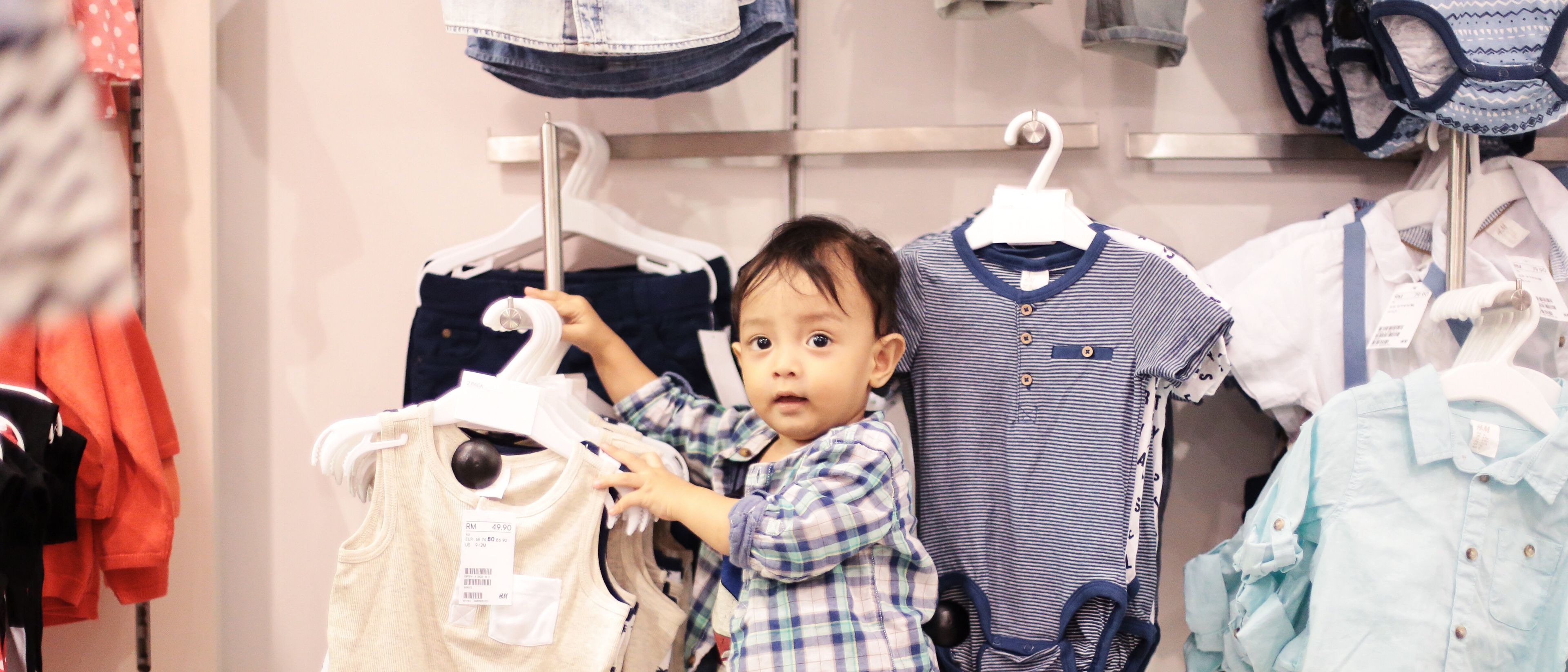 Kid in a cloth store