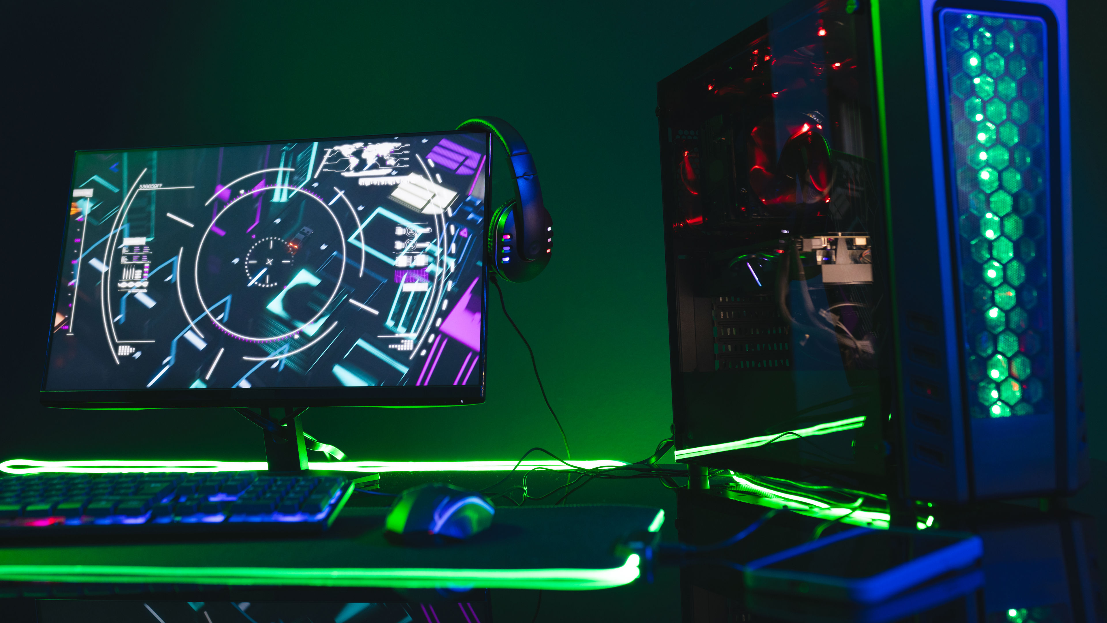 Gaming computer setup with light green LED lights and matching gaming accessories.