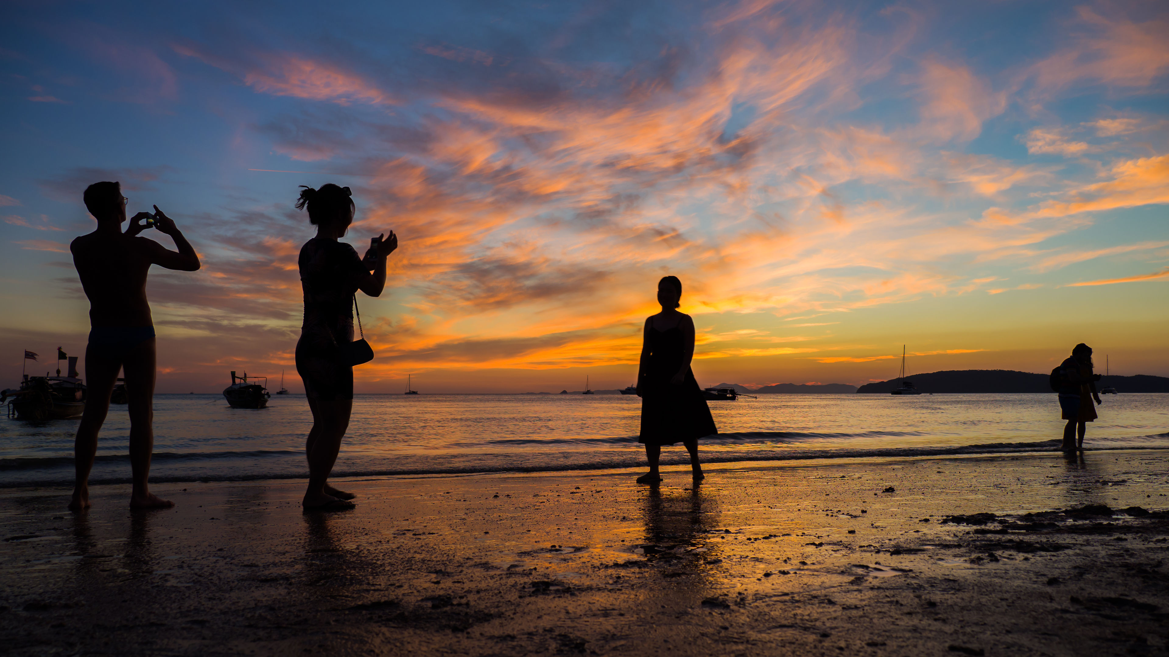 Silhouette of people taking photos at Sunset in Ao Nang Krabi province Thailand