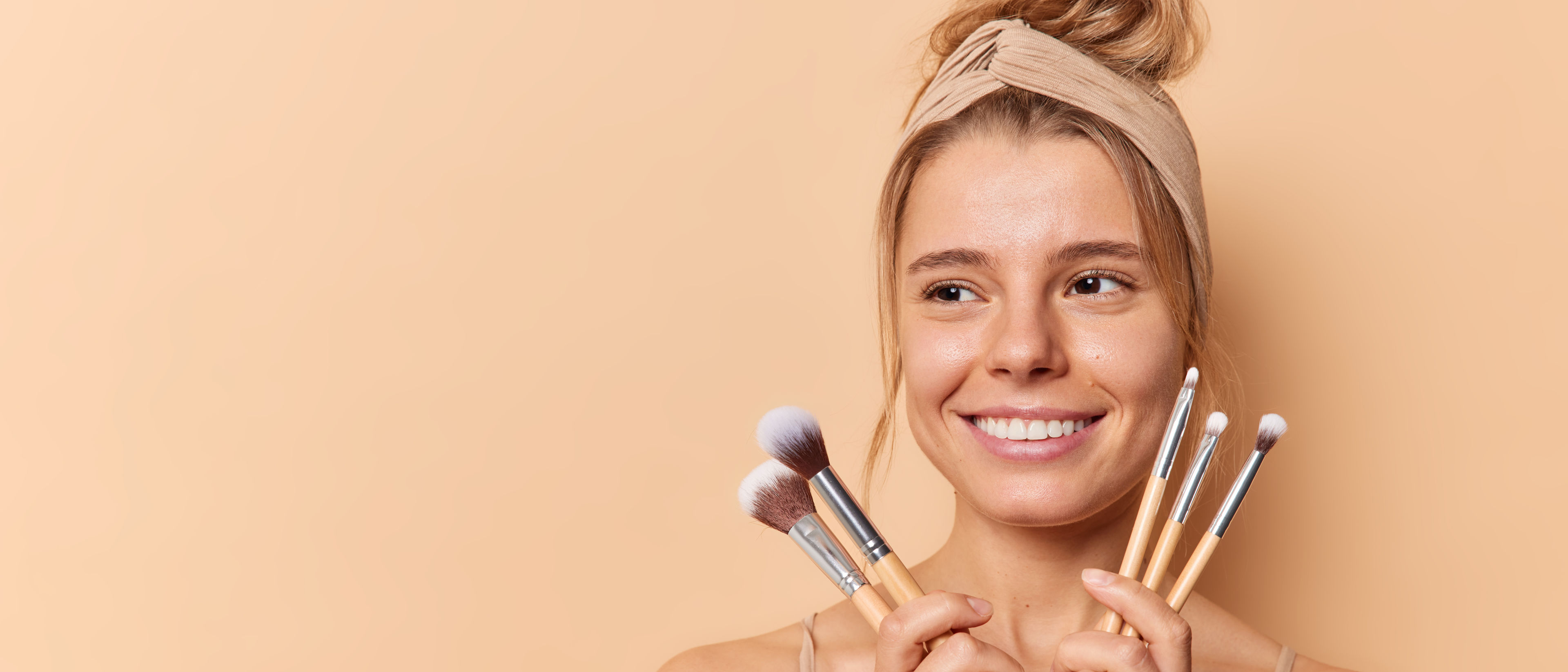 Woman holding makeup brushes