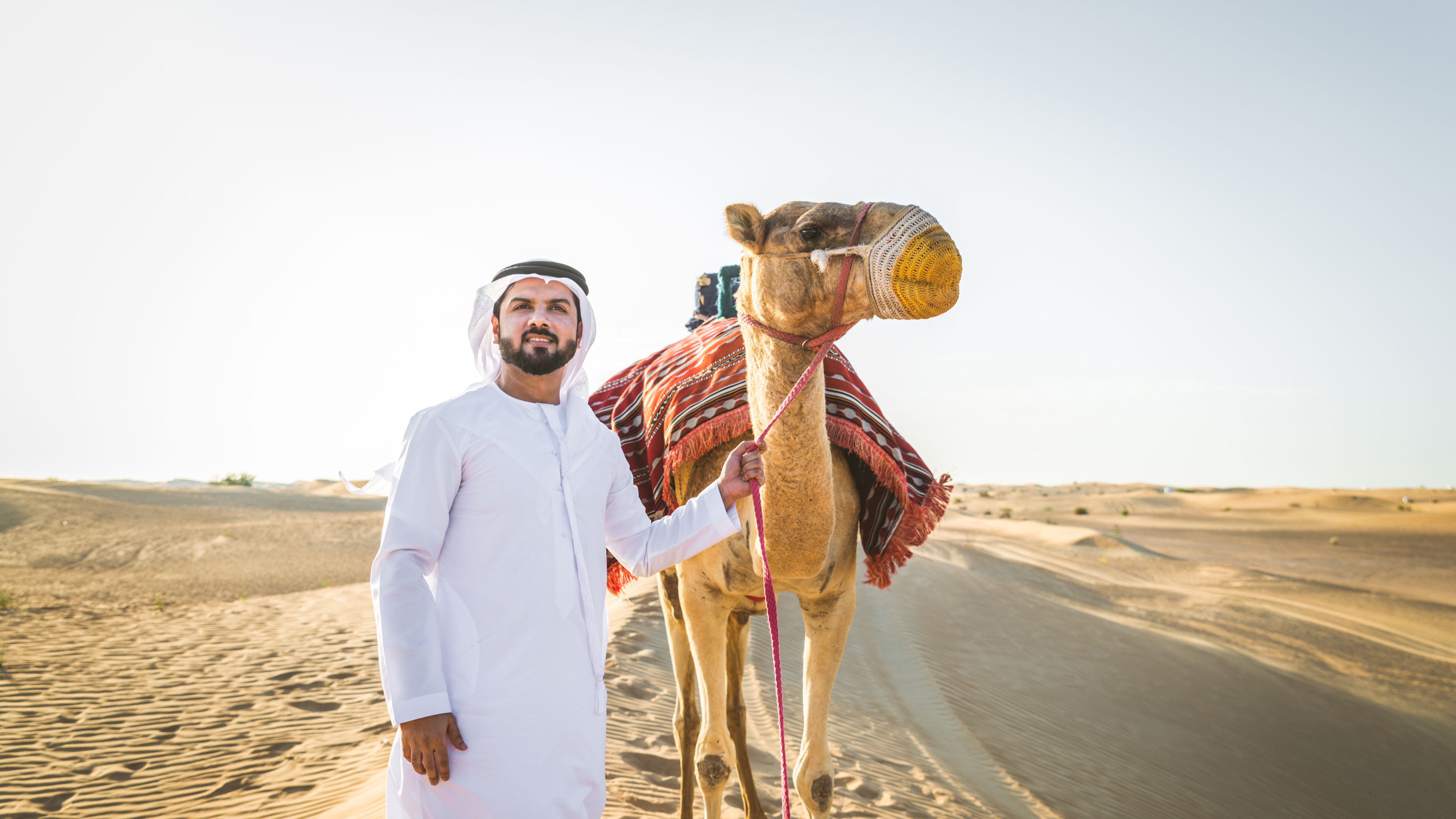 A young man with a camel 