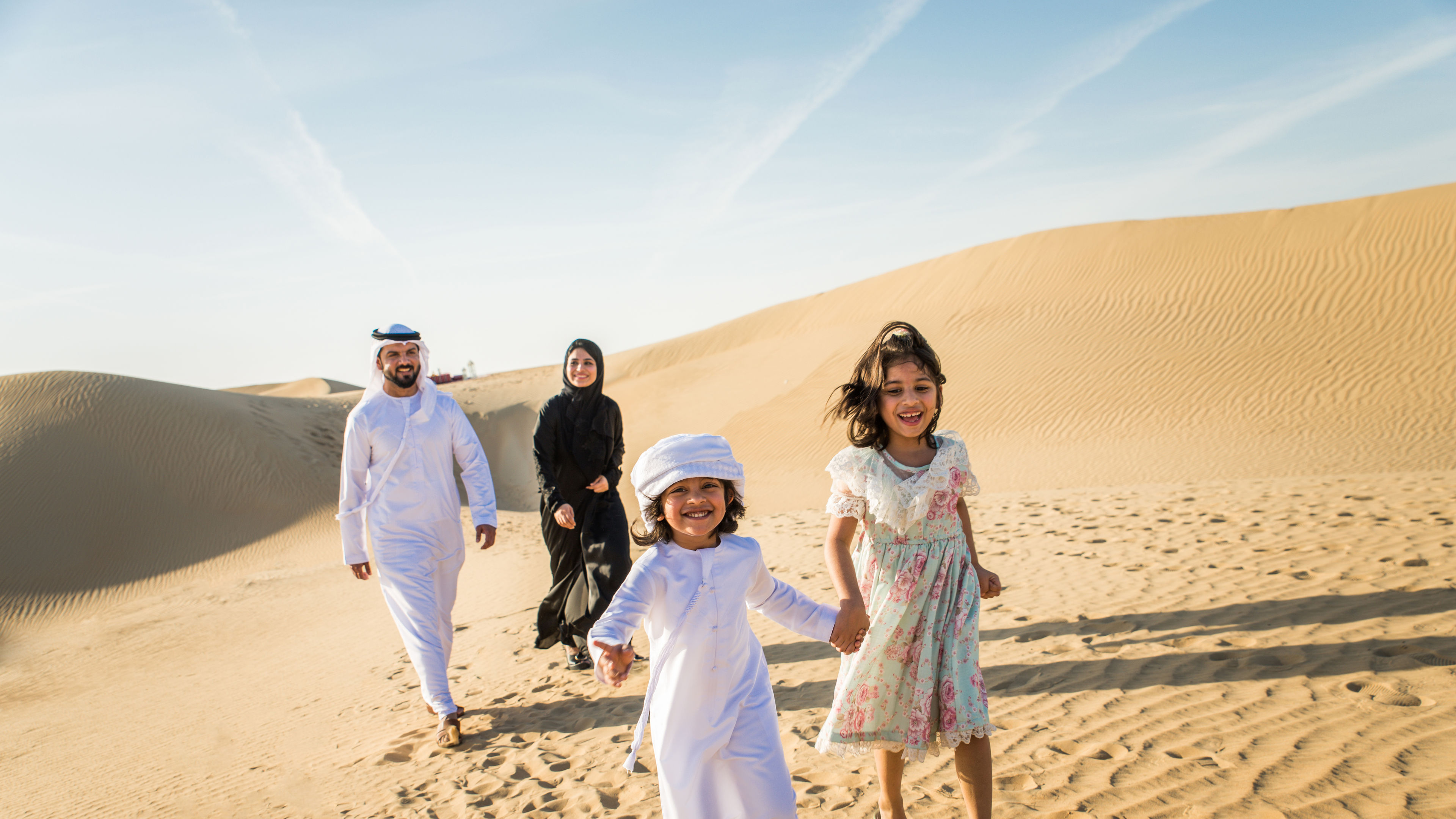 An Arabian family of four in a desert 