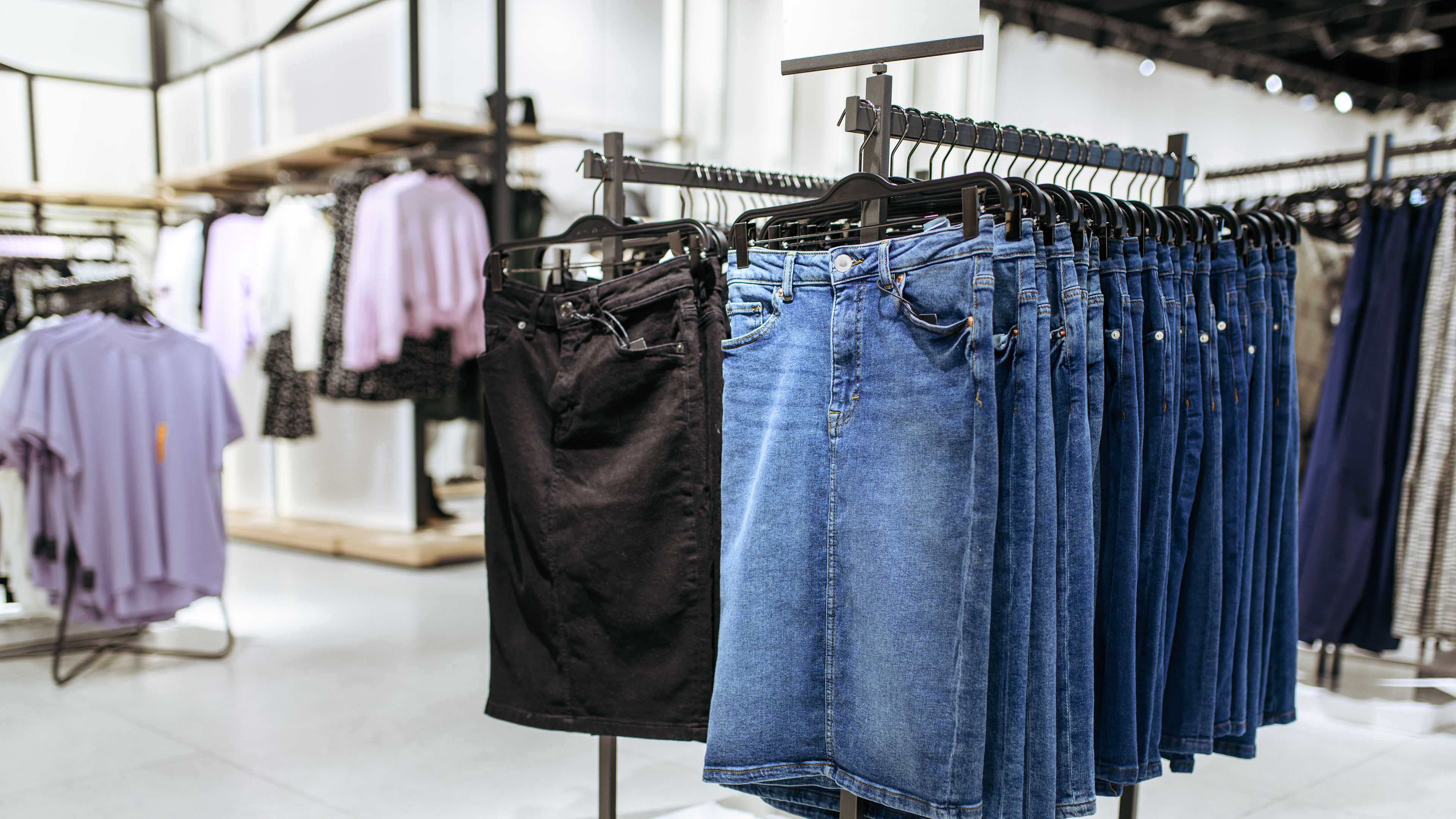 Denim skirts collection on racks in clothing store