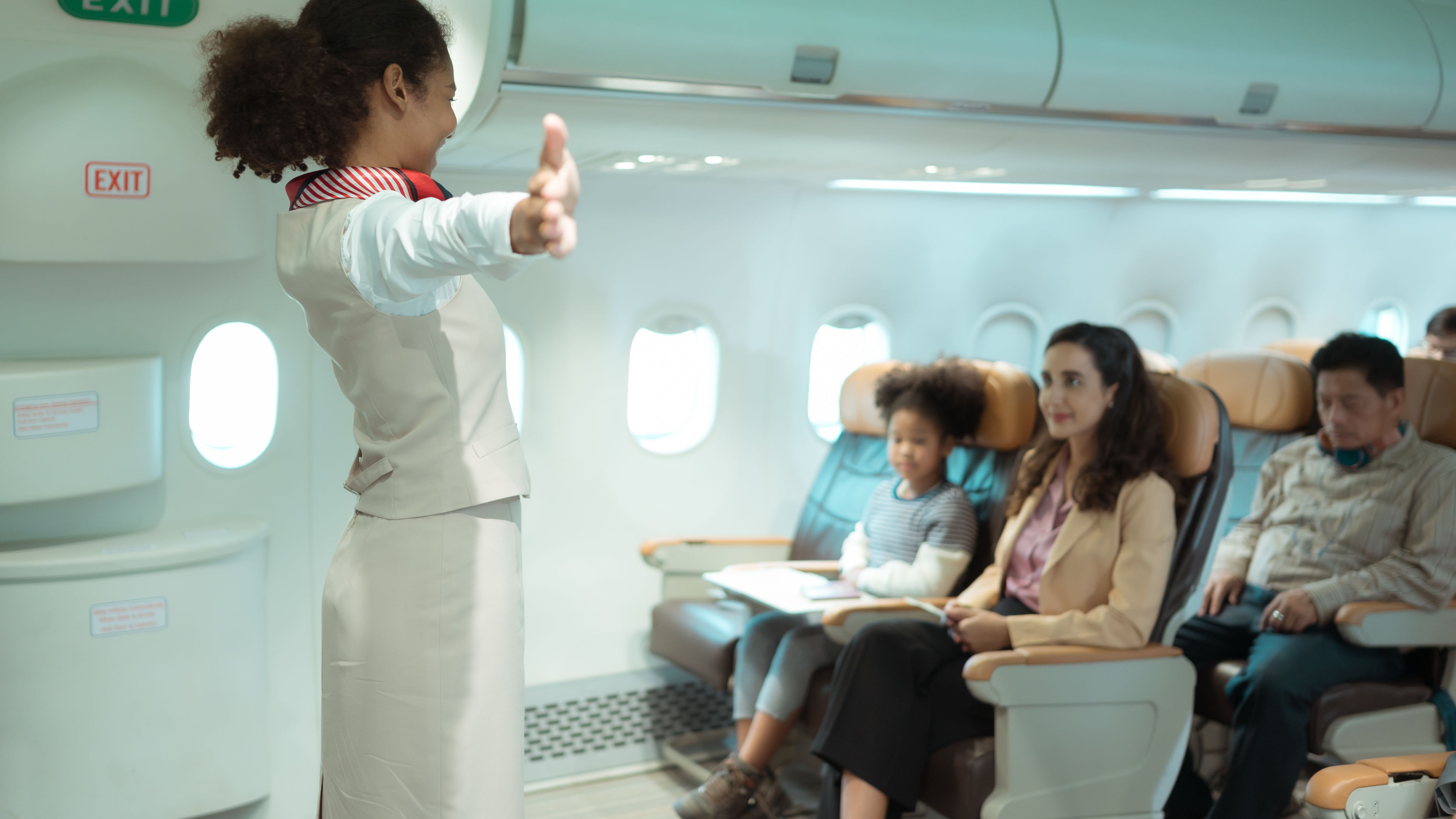 Flight attendants show how to use safety devices and recommend emergency exits 