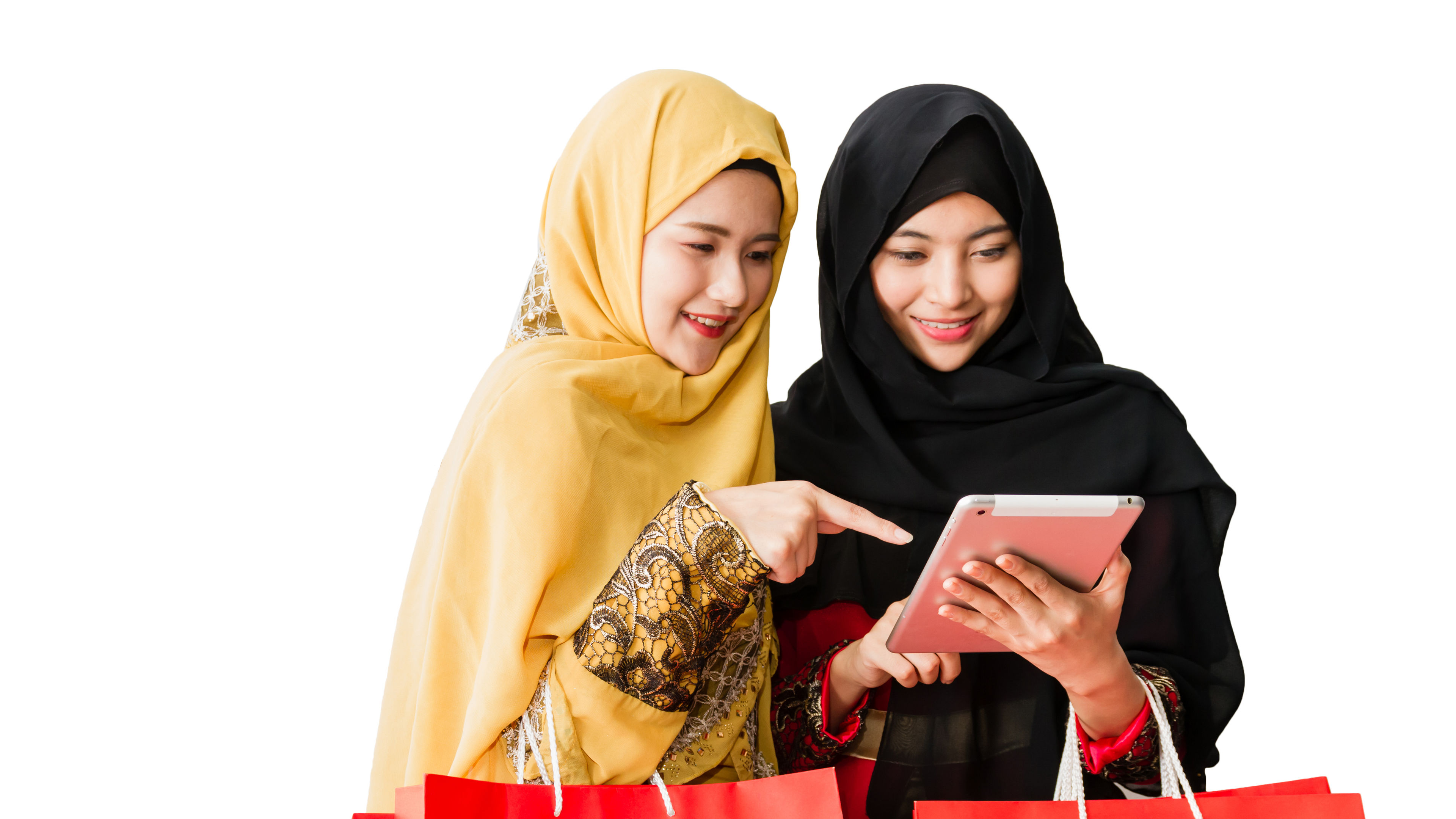 Two young women shopping products using tab