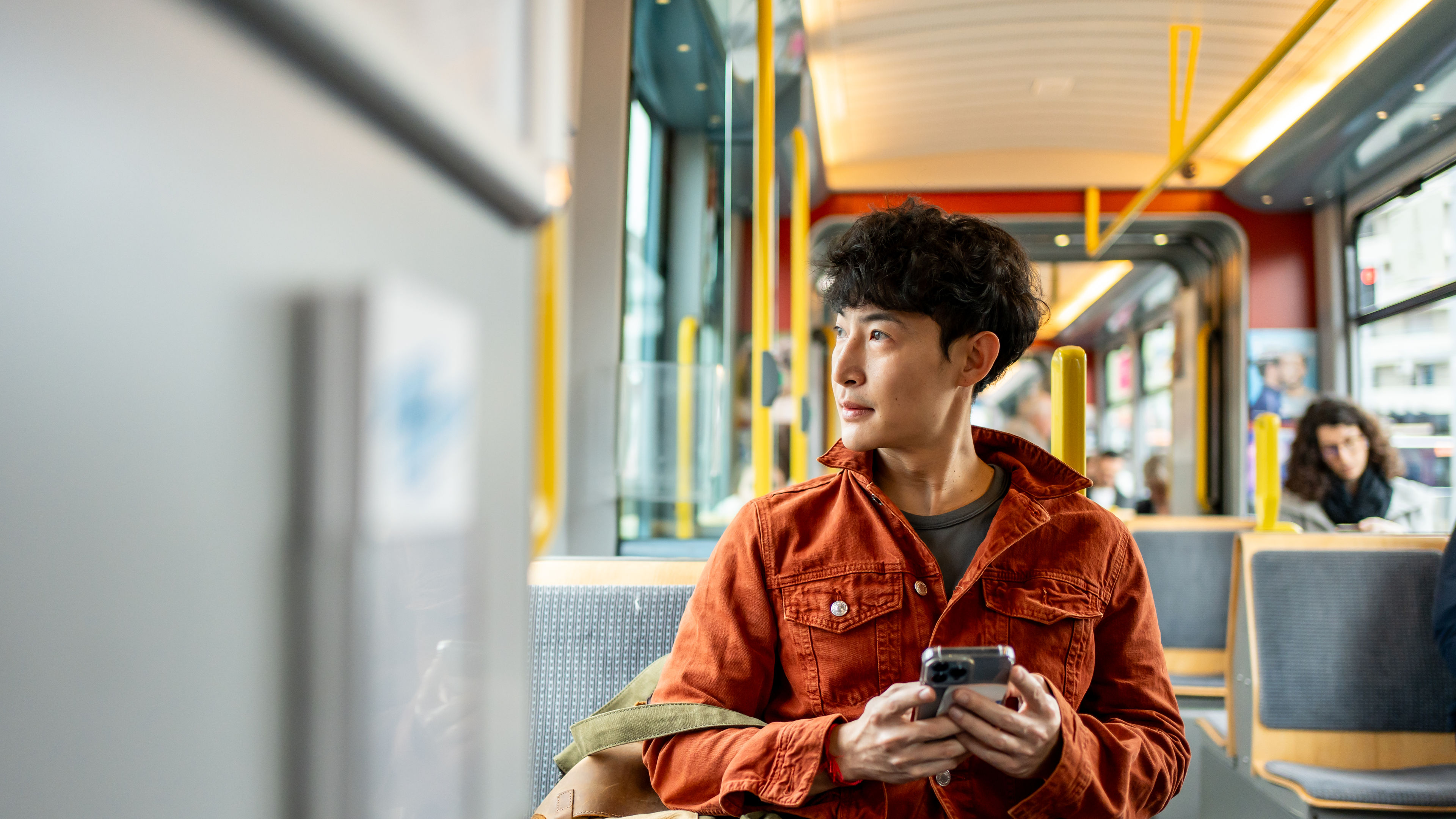 Young Man Riding on a Public Transportation Bus