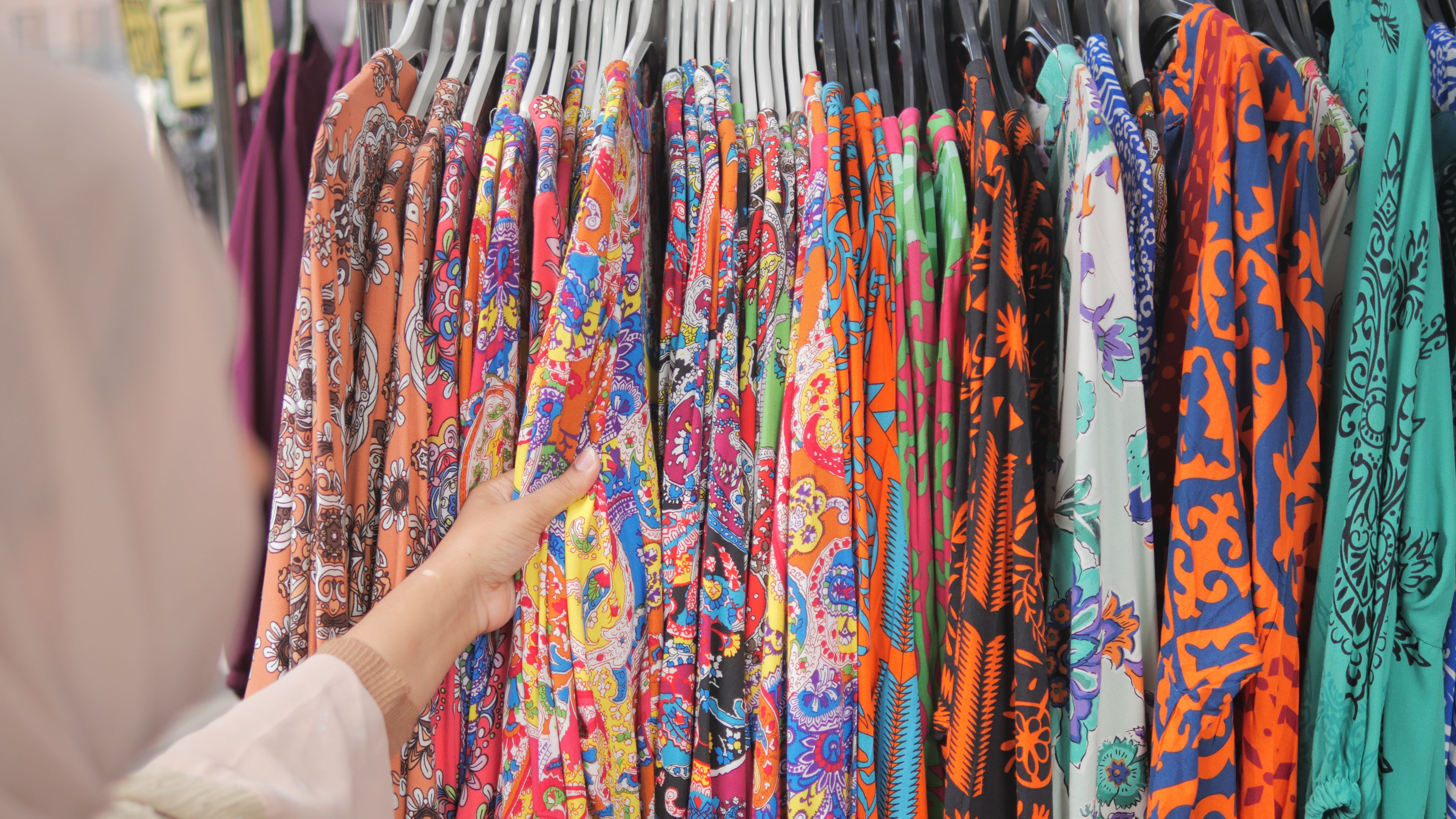 A row of some colorful dresses in a shopping mall 