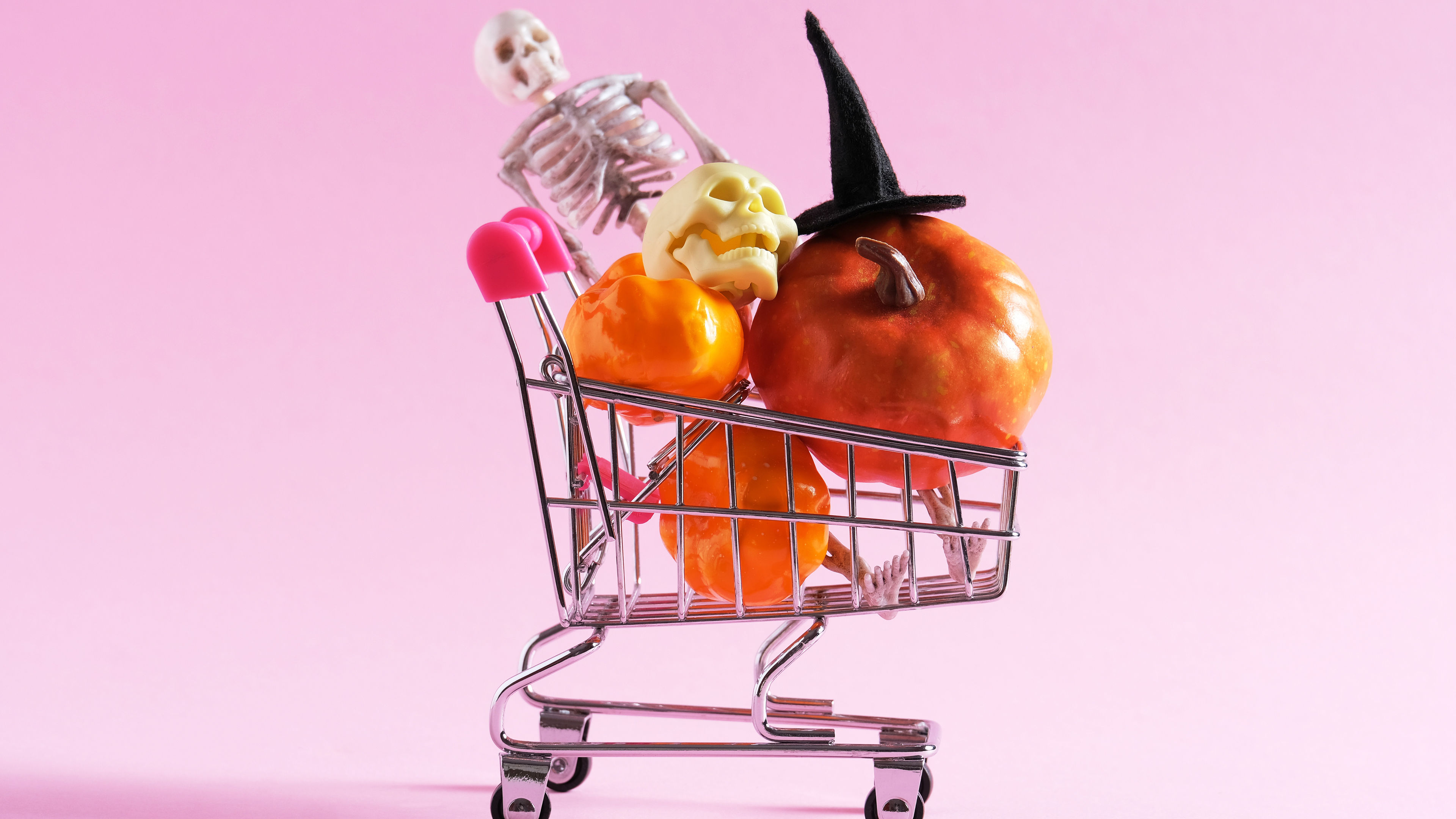 A shopping cart with different Halloween decorations 