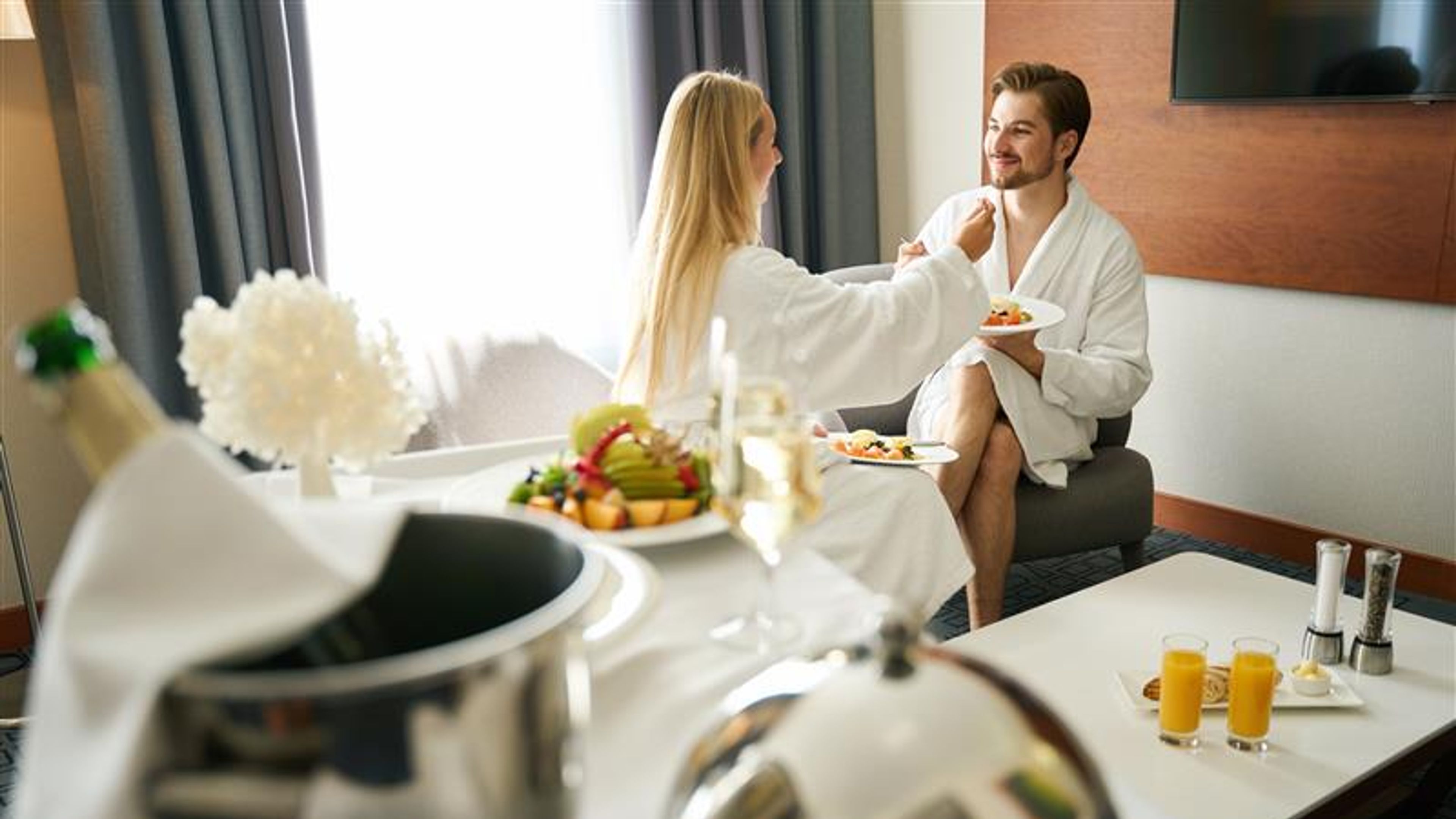 A couple enjoying in room dining at home 