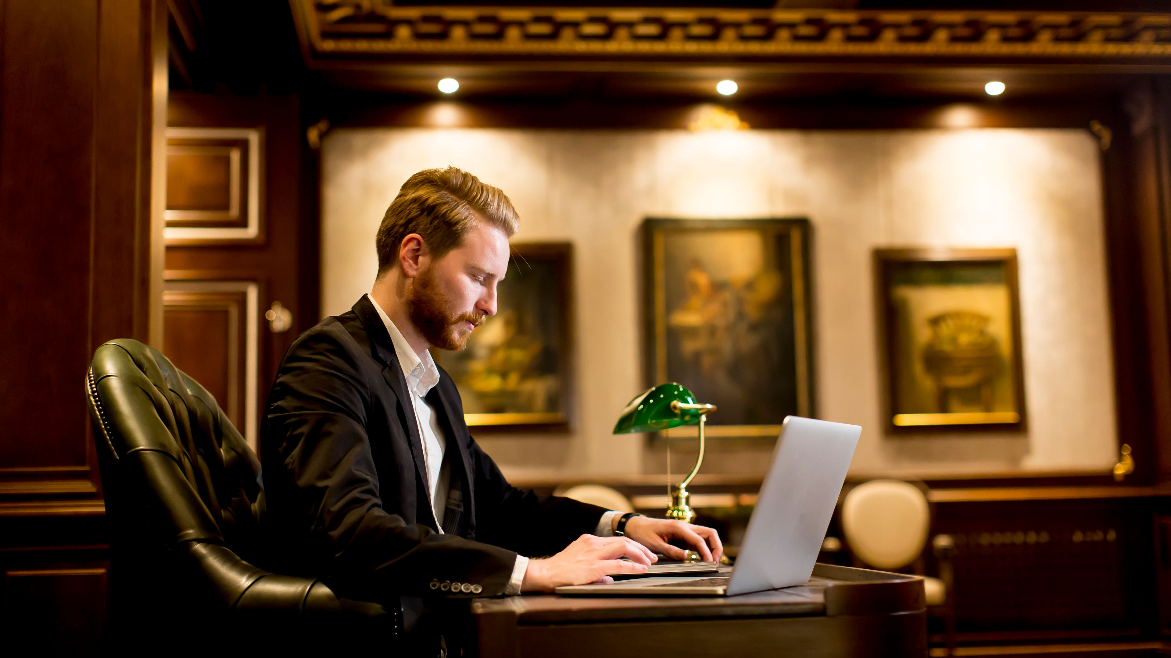 A man working with a laptop in a room 