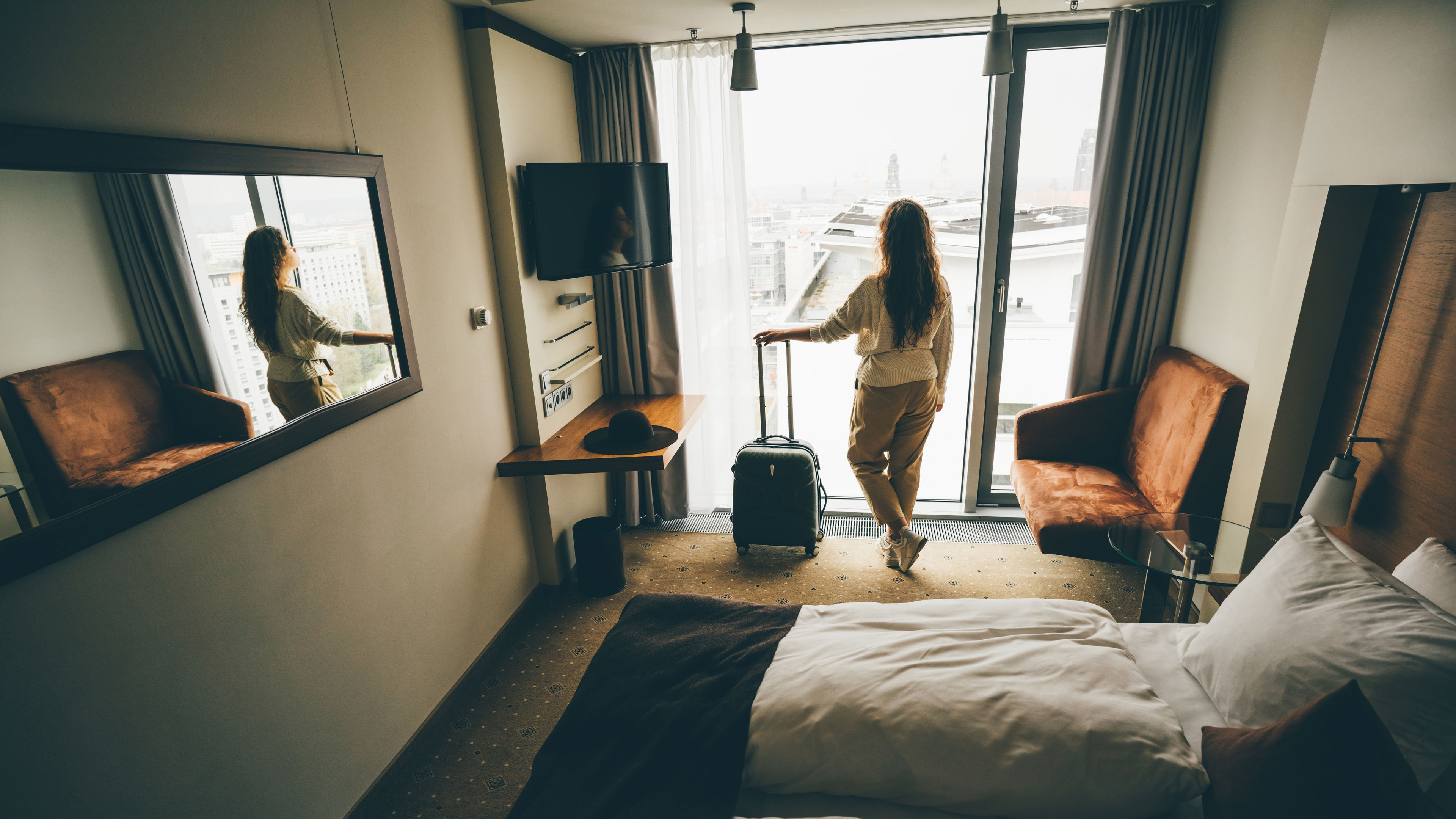 A woman in a hotel room 