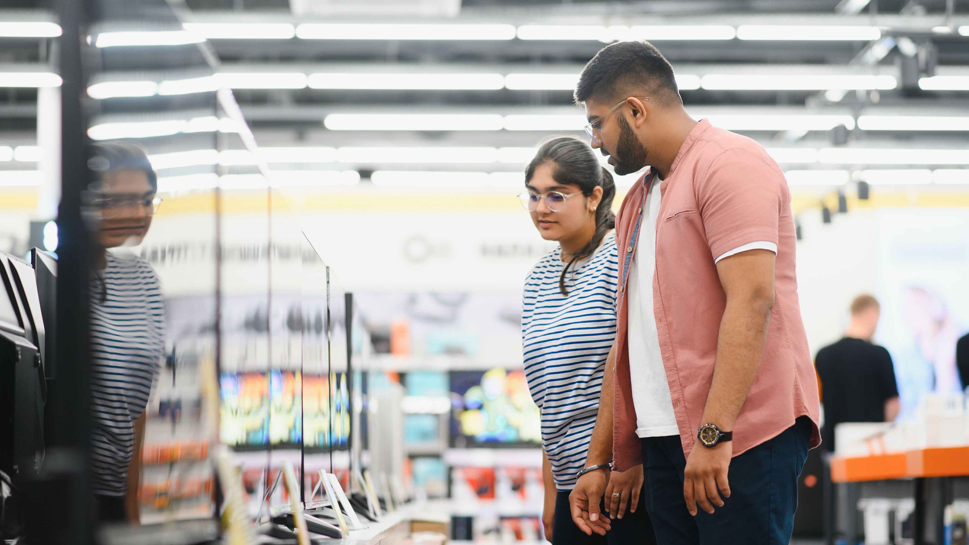 Couple in shopping. They are looking for new tv 