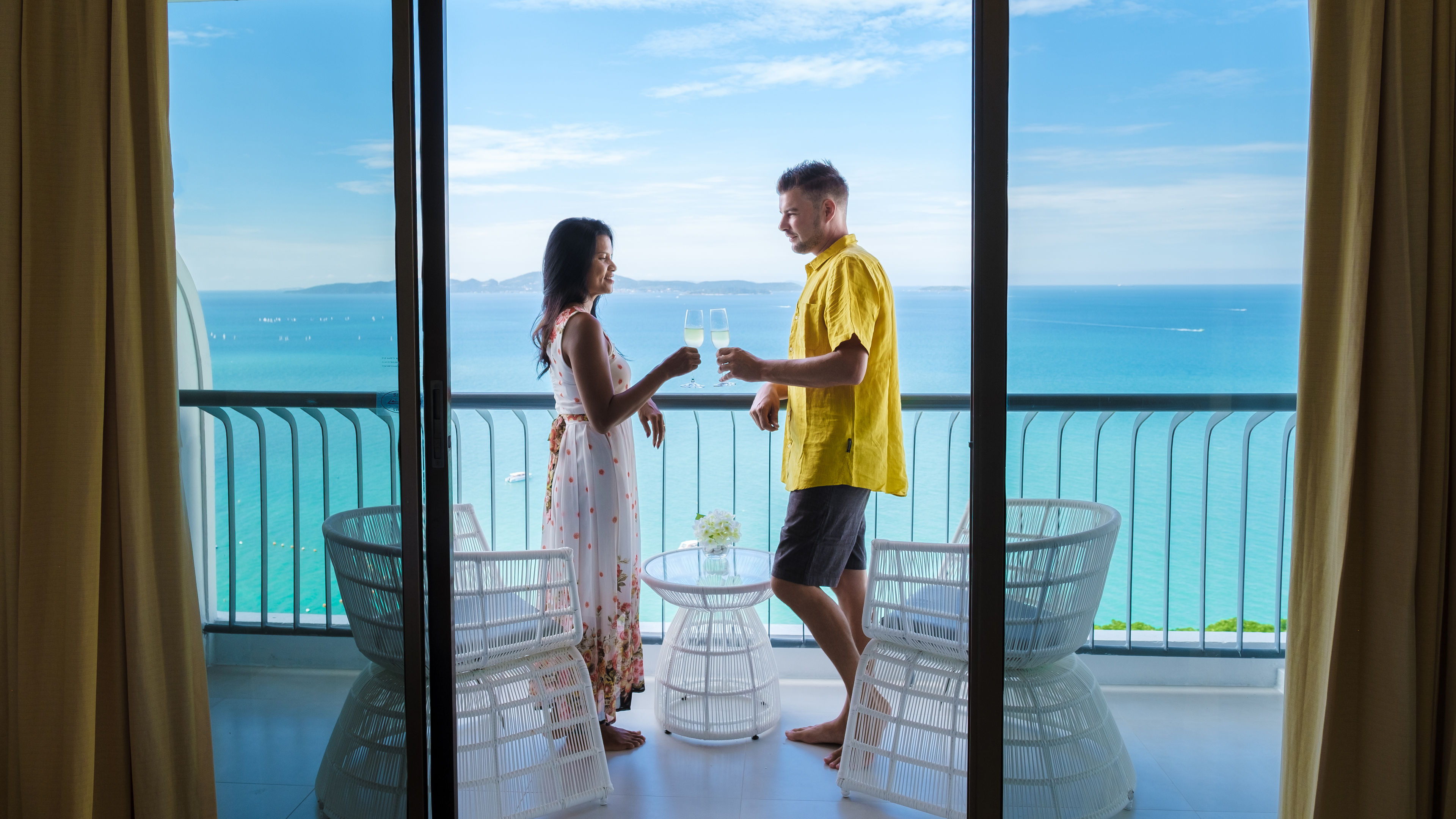 Image of Couple with champagne on balcony 