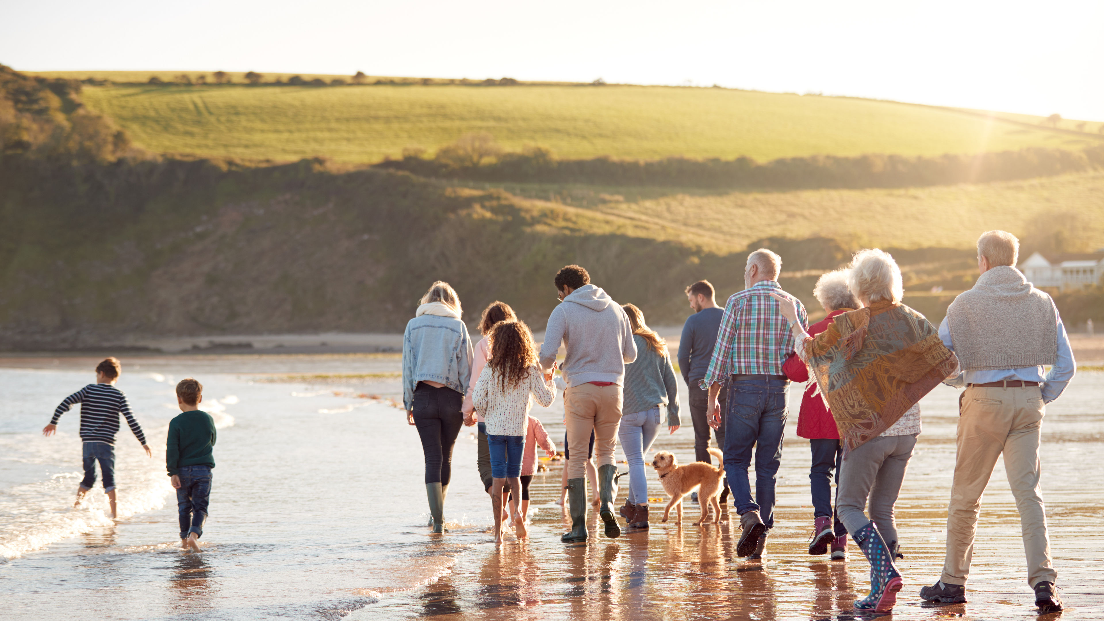 Family with Dog walking along the shore
