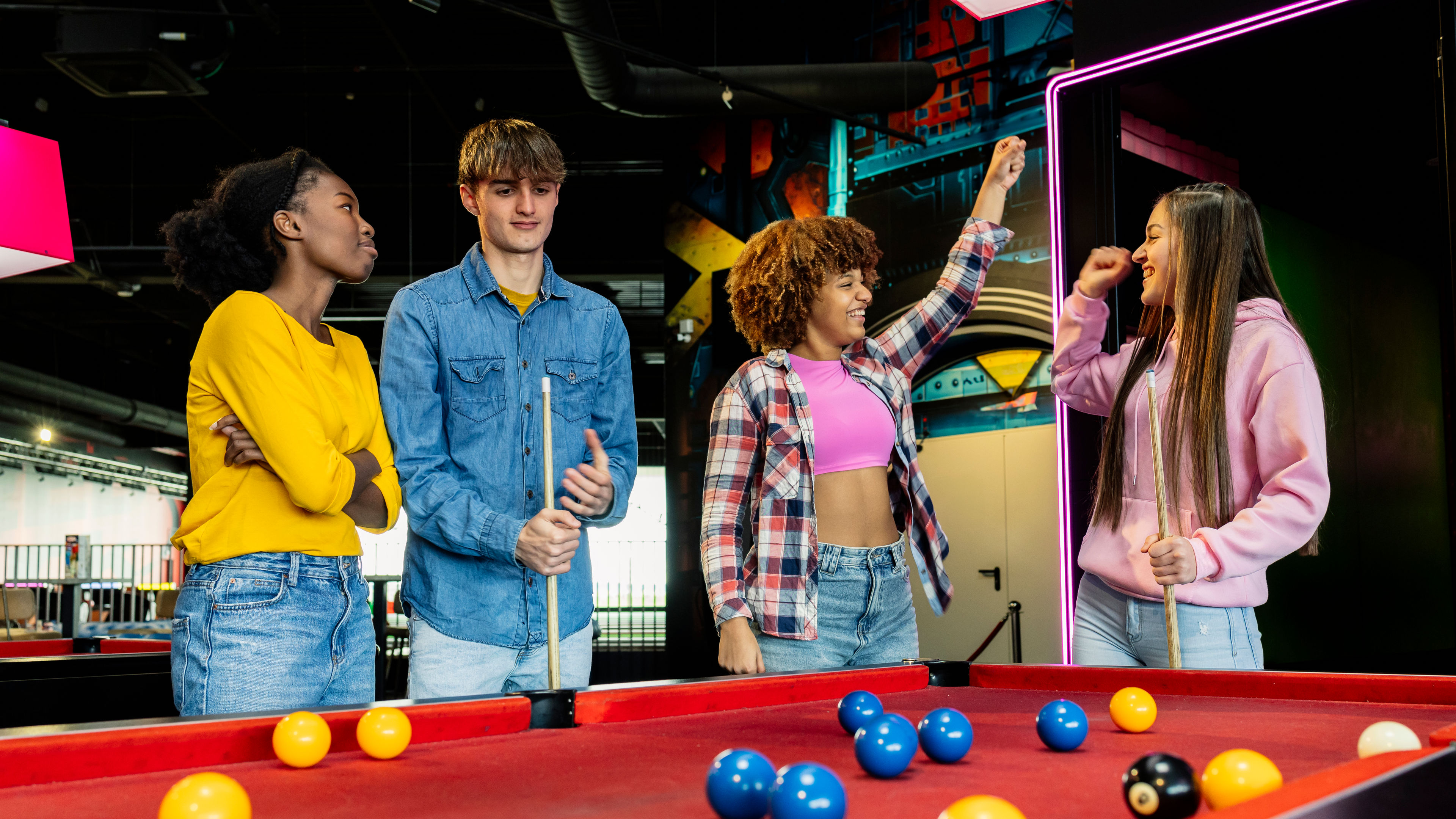 Friends Engaged in a Competitive Game of Pool. 