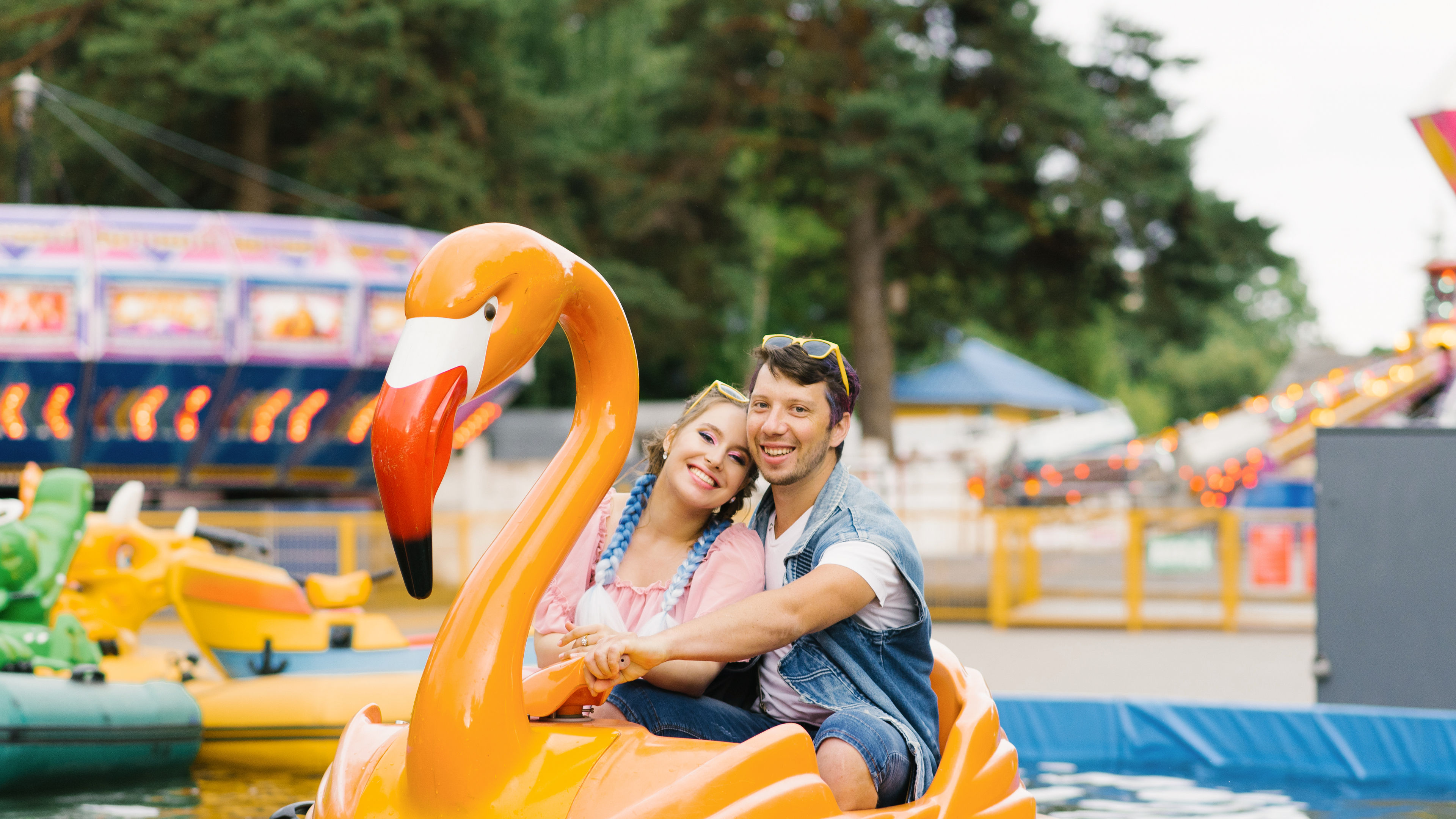 Happy couple in love riding a water ride 