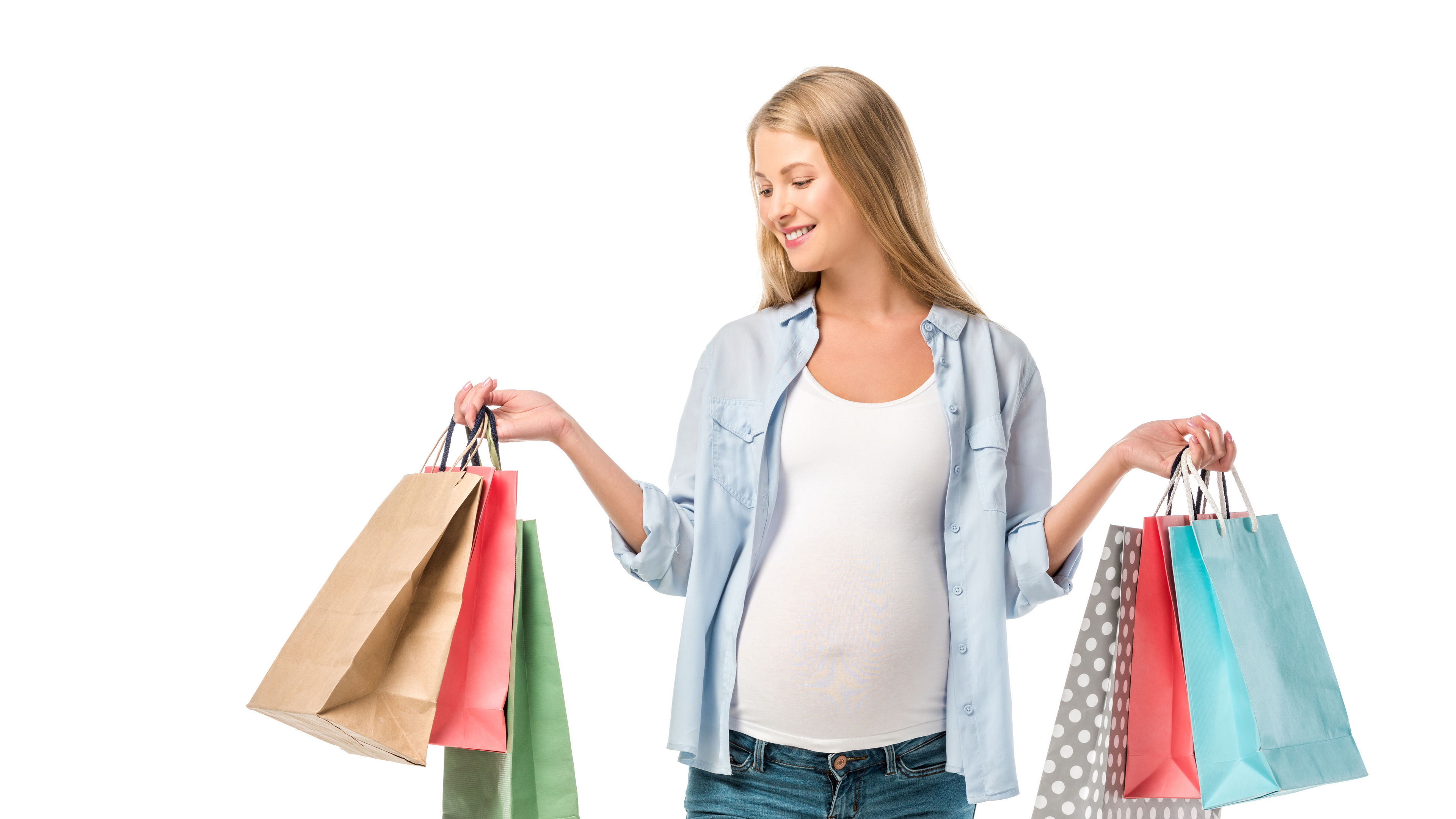 Smiling pregnant customer holding shopping bags. 