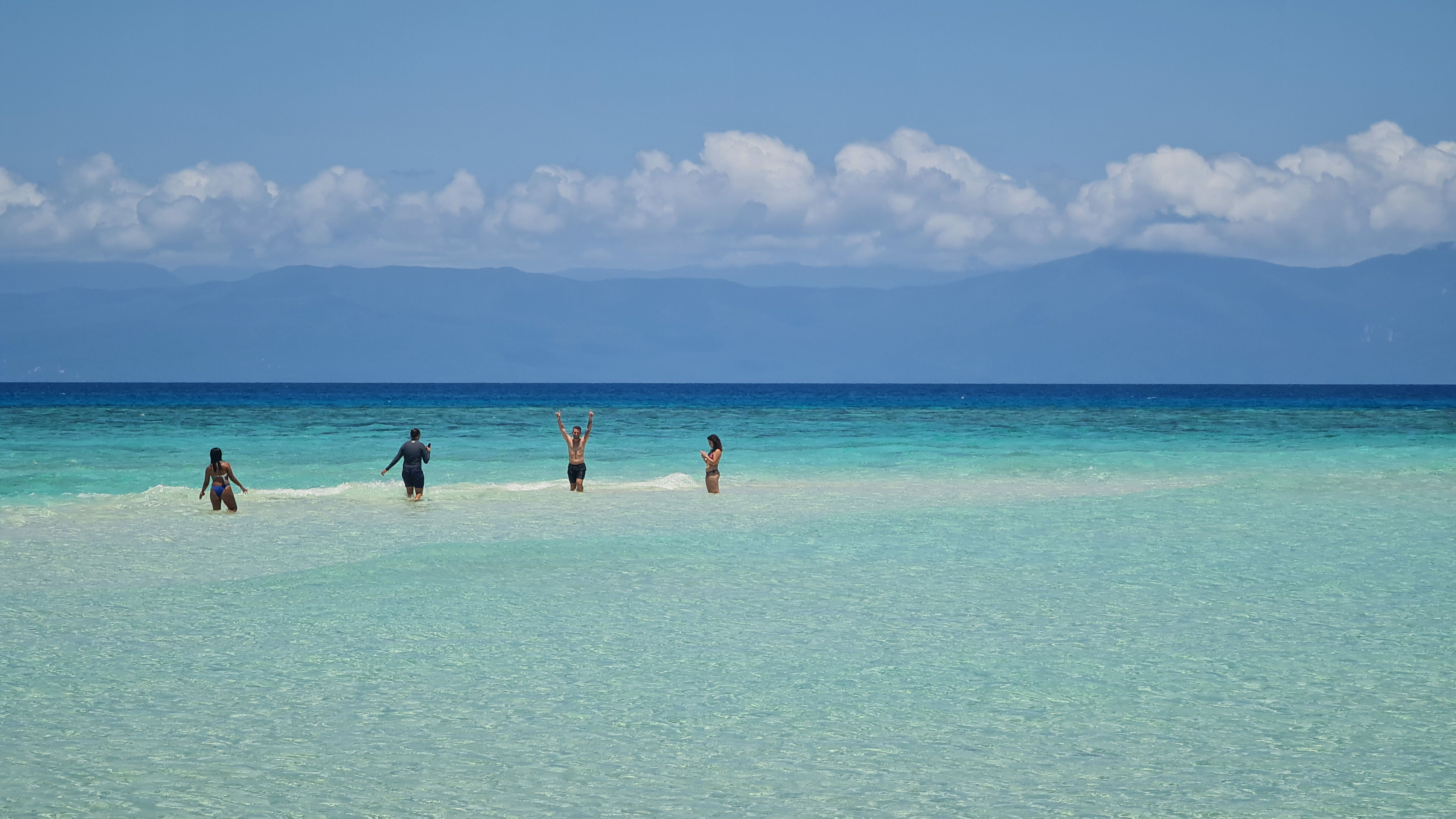 Some people are enjoying their time on the beach. 
