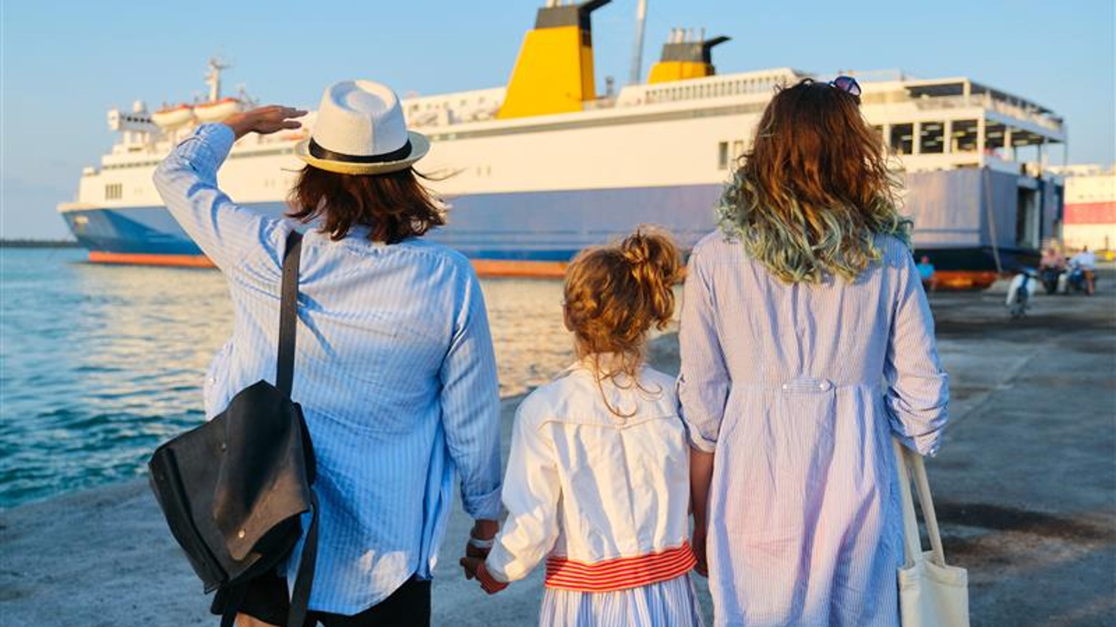 Three people waiting for a ship
