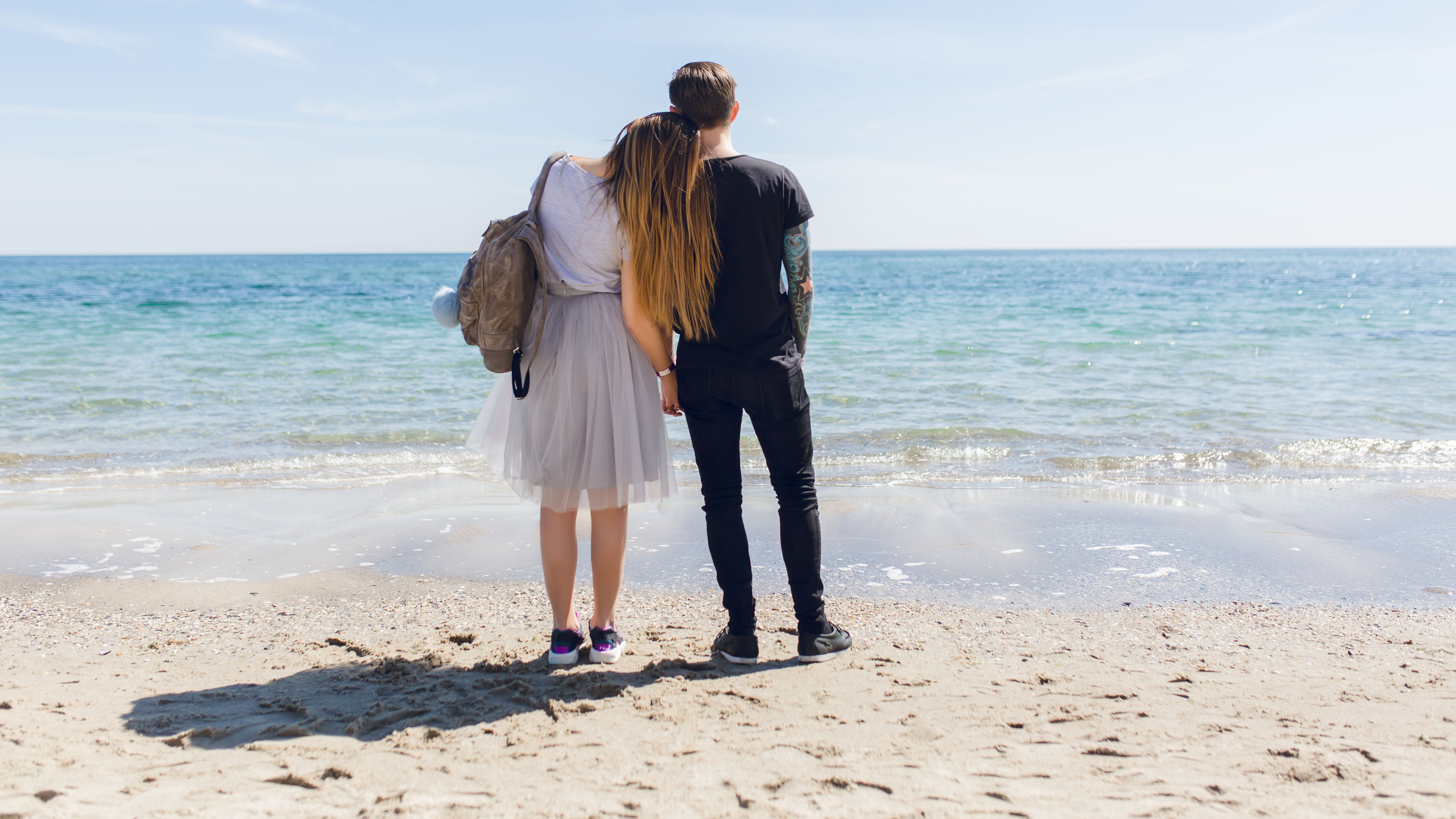 Young couple is standing near sea 