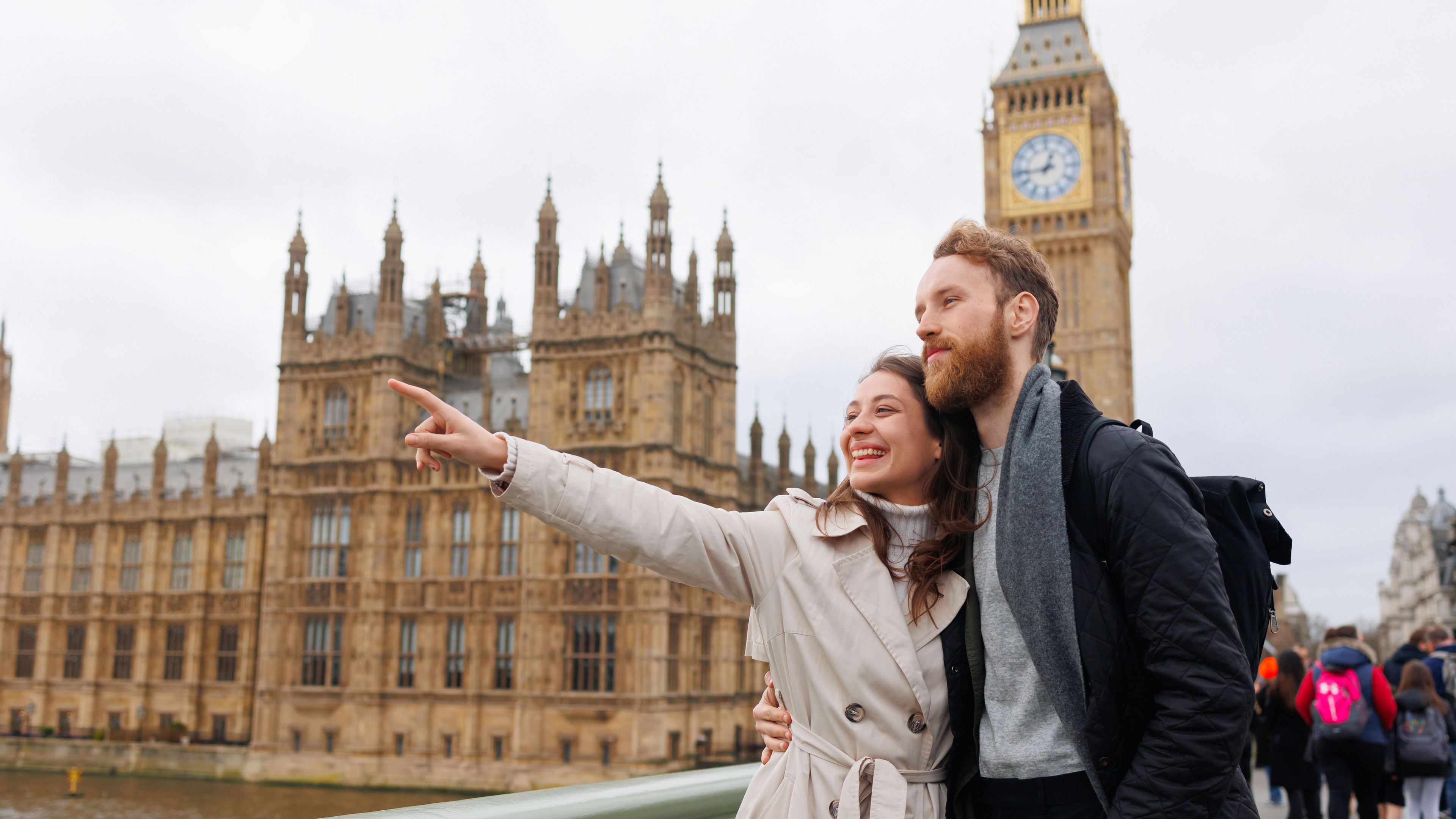 Young cute couple looking at famous places in the UK. 